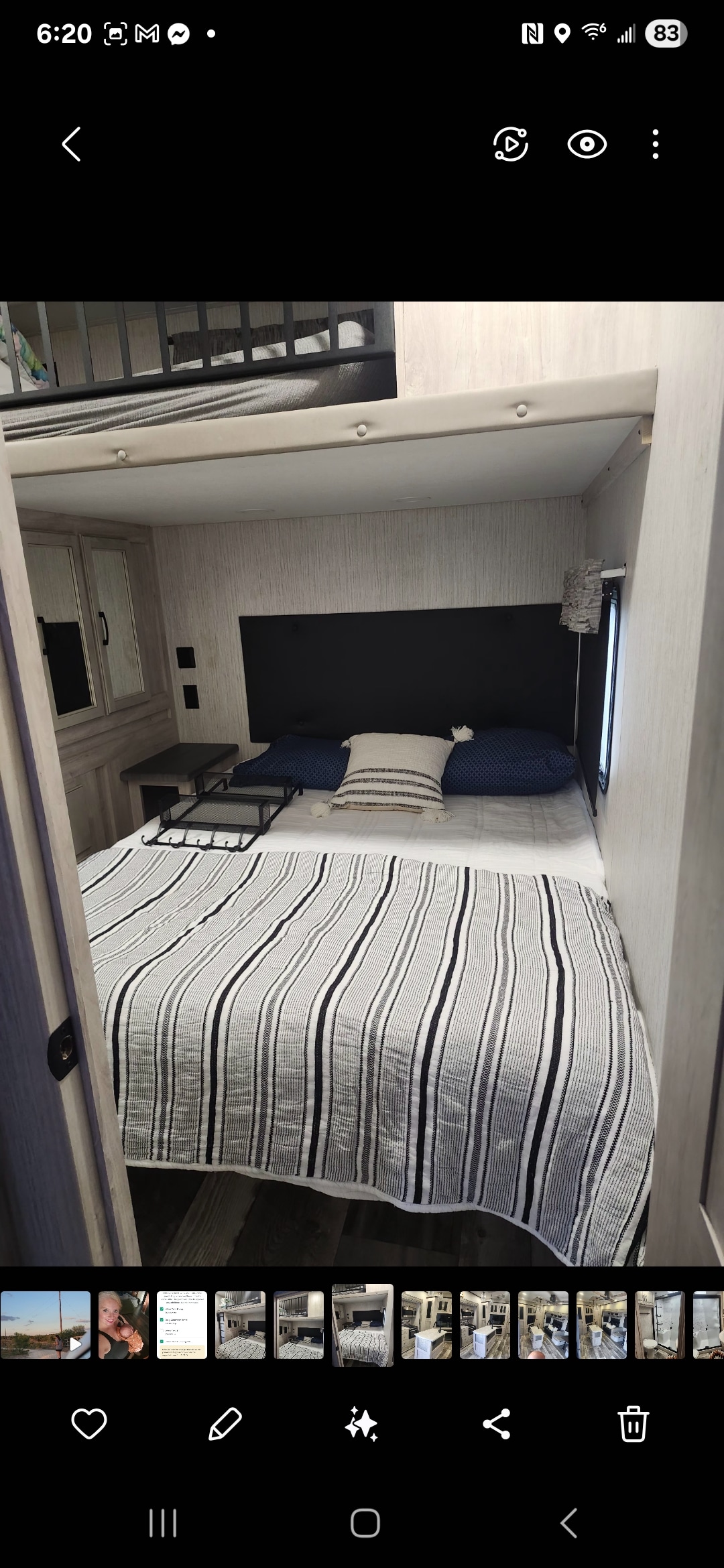 Cozy RV rental bedroom features striped bedding, a dark headboard, and an overhead bunk bed in a light wood interior.. Forest River Sierra 2023