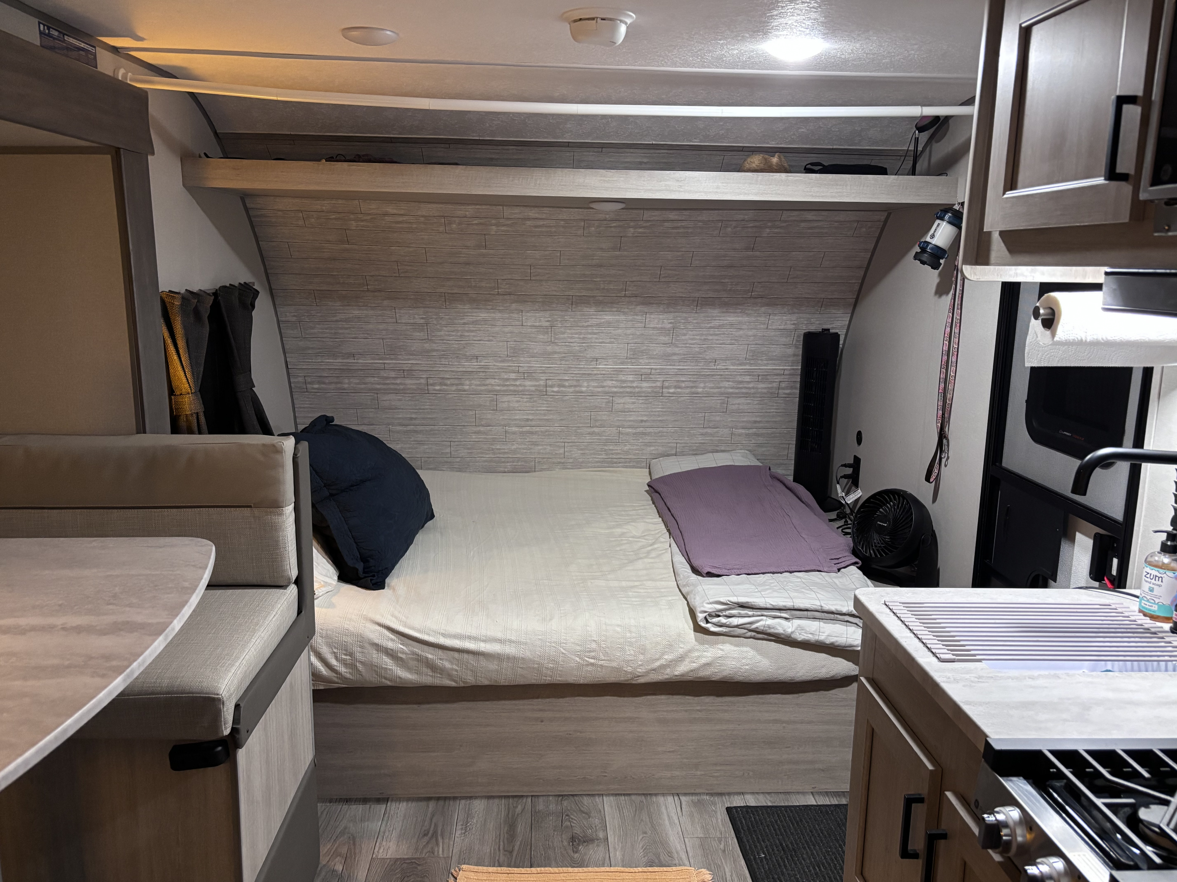 This RV rental's cozy interior features a bed, dinette, and kitchen, designed for compact comfort on your travels.. Coachmen 184BH 2025