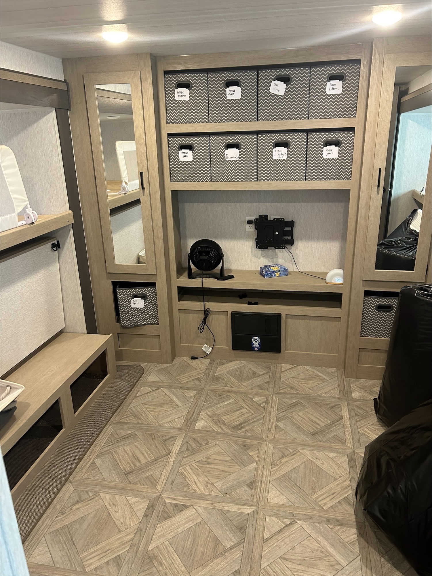 Functional RV rental bedroom with bunk beds, custom storage, and labeled bins for an organized travel experience.. Forest River Wildwood 2024