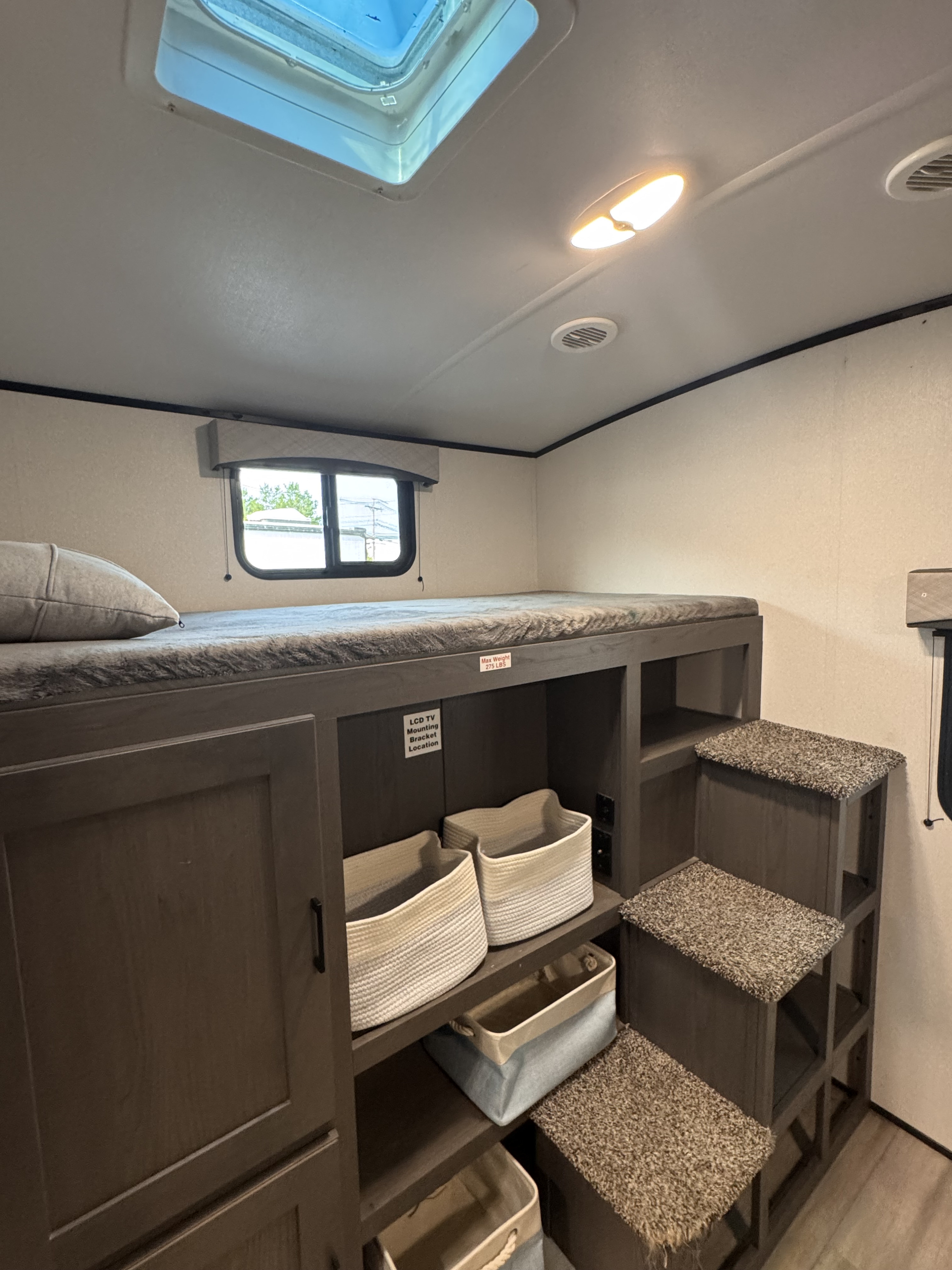 This RV rental features comfy bunk beds, integrated storage, and carpeted steps for easy access in a compact living space.. Cruiser RV Embrace Ultra Light 2021