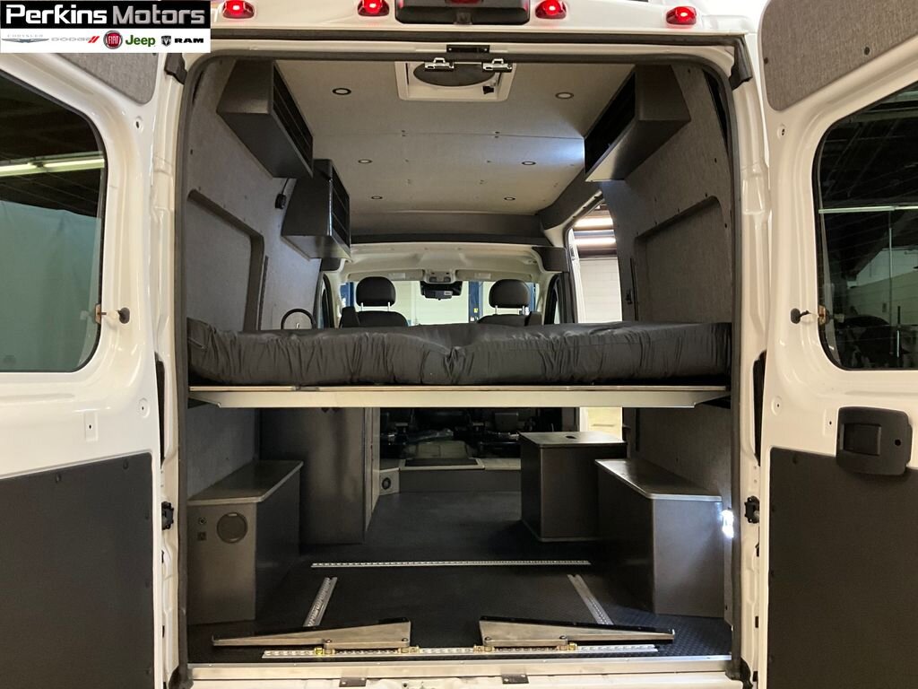 Explore this spacious rv rental van conversion. Features a raised bed, custom storage, and comfortable interior for adventure.. Ram Promaster 1500 2024