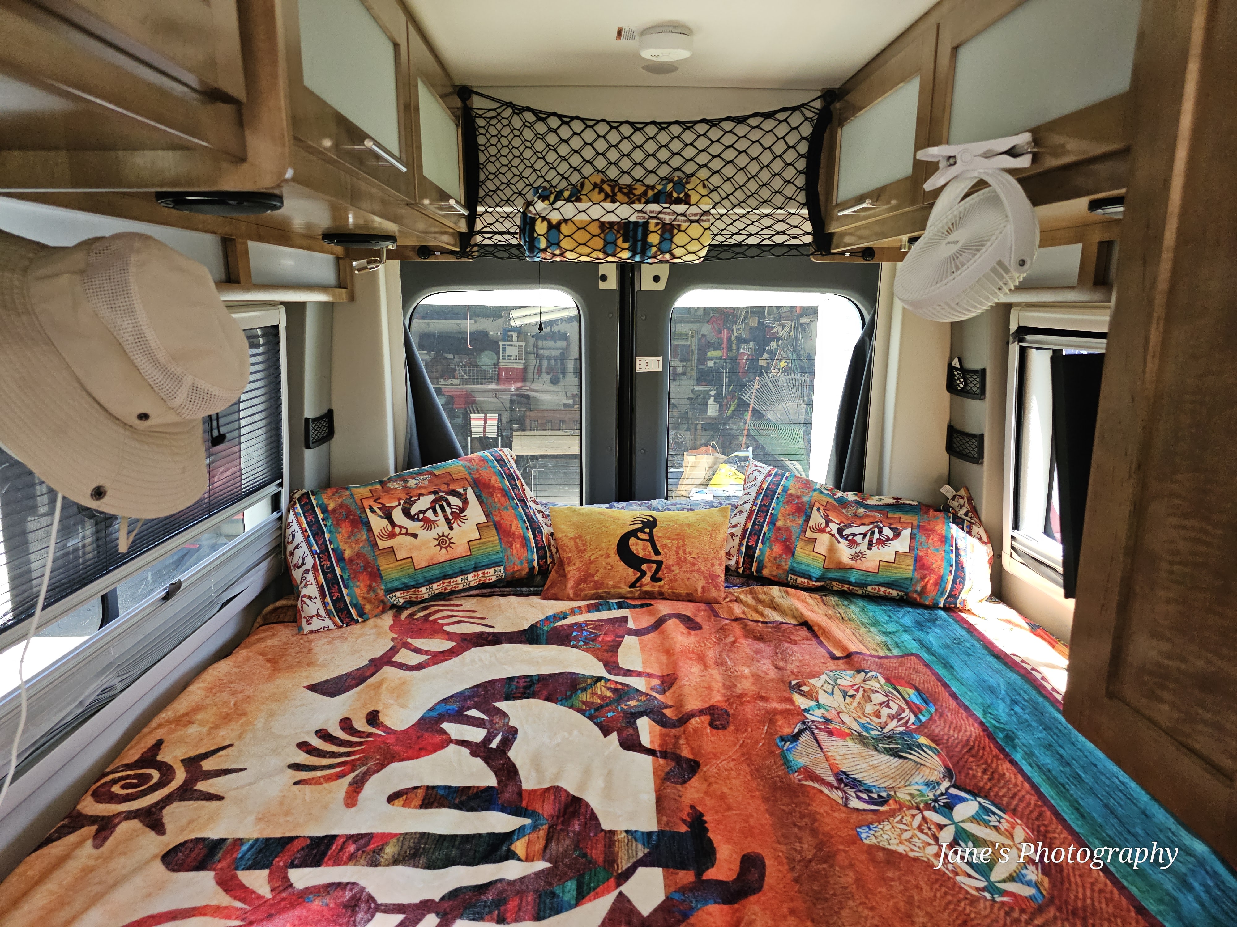 Inside an RV rental: a vibrant bed with Southwestern patterns, ready for comfortable travel & camping adventures.. Forest River Coachmen Crossfit 2019