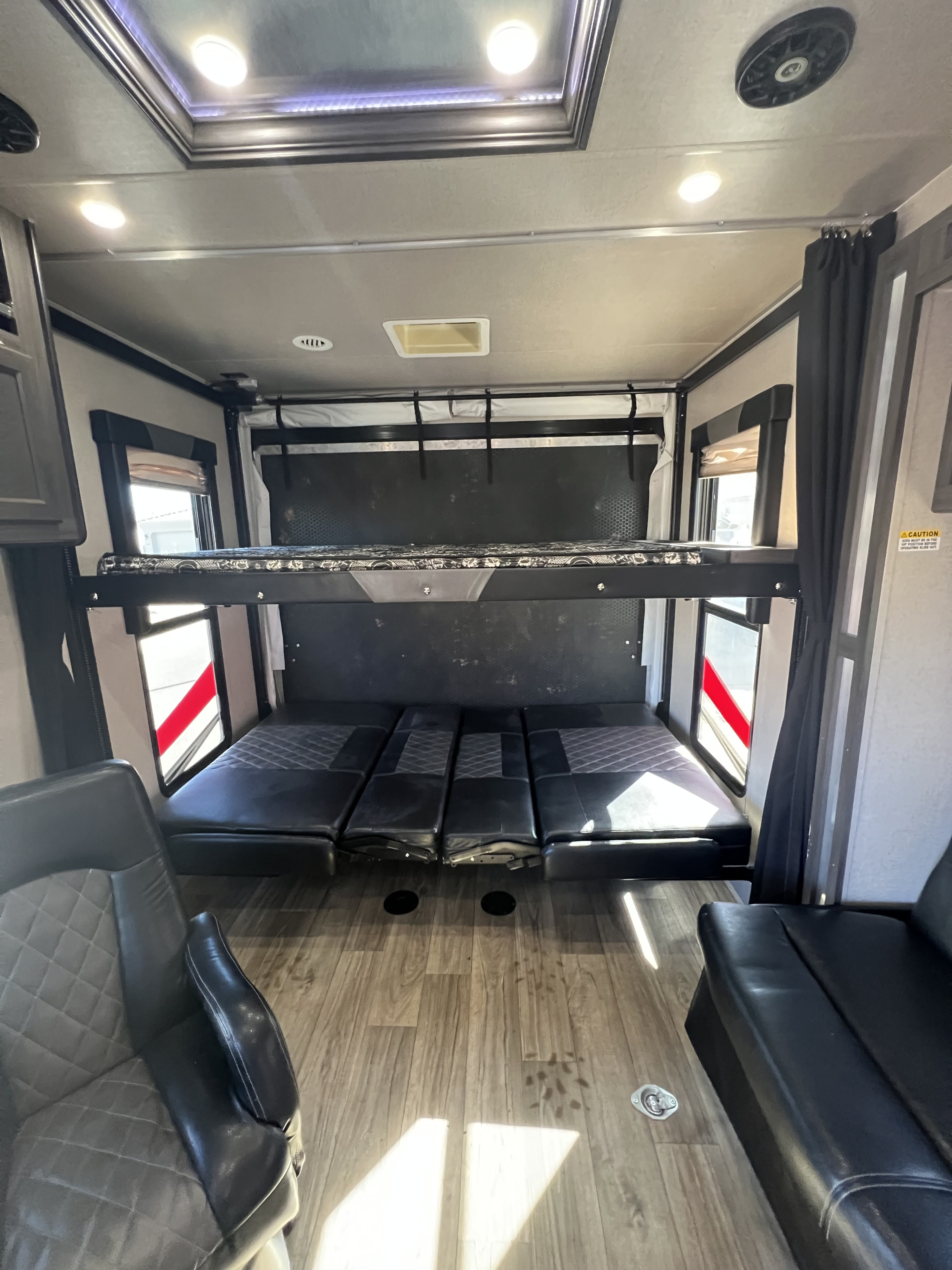 Explore this RV rental's versatile toy hauler interior, featuring bunk beds, convertible sofas, and captain's chairs.. Genesis Supreme Rv Genesis Supreme 2019