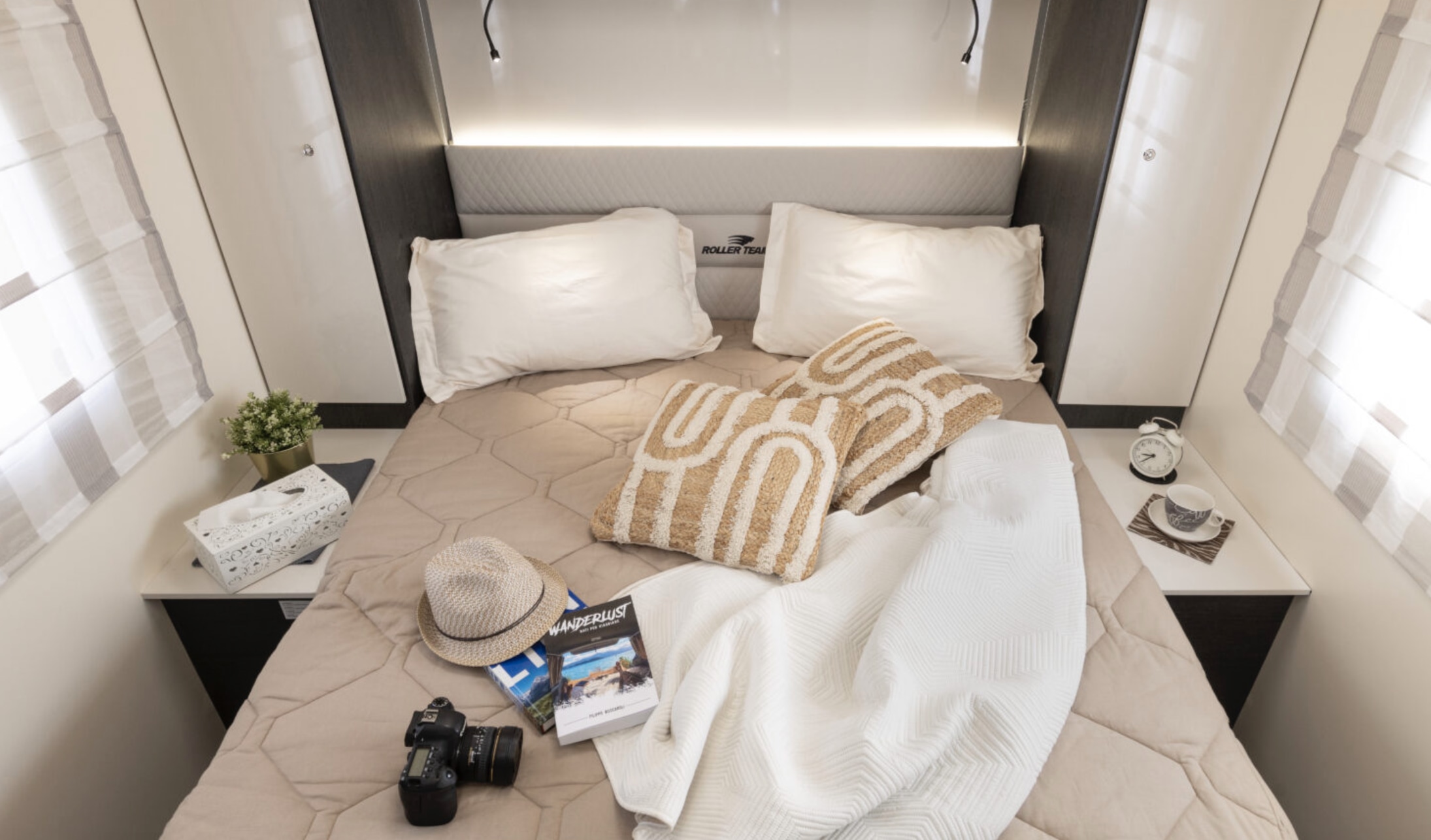 Inviting RV rental bedroom with a comfy bed, travel-themed decor, and amenities for a perfect journey.. Roller Team Zefiro 696 2026