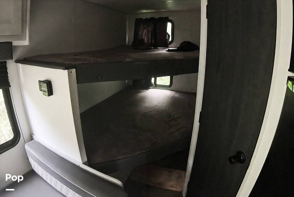 Cozy bunk beds in this rv rental offer a comfortable sleeping area. Features two mattresses and natural light from windows.. Forest River Wildwood FSX Platinum 2021