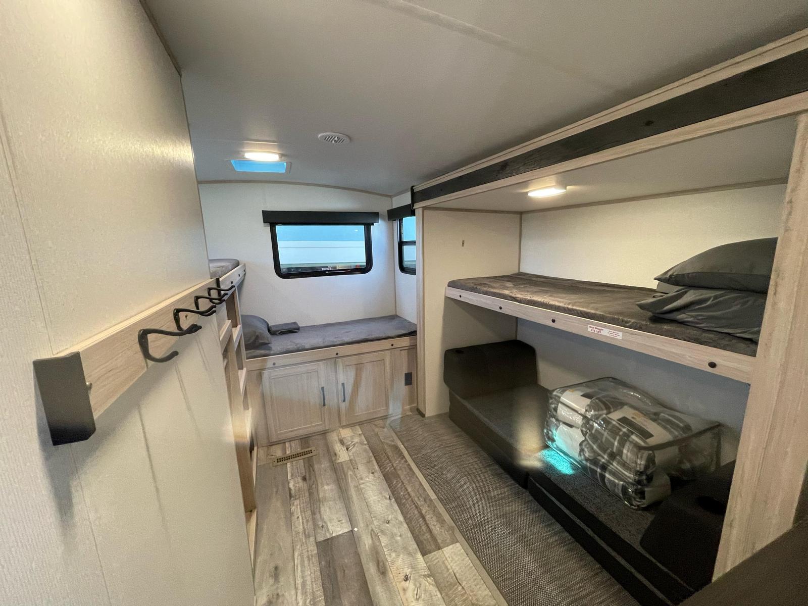 RV rental: Spacious interior featuring bunk beds, cozy seating, wood flooring, and storage. Ideal for family adventures.. 2022/SNDC SUDANCE 2022