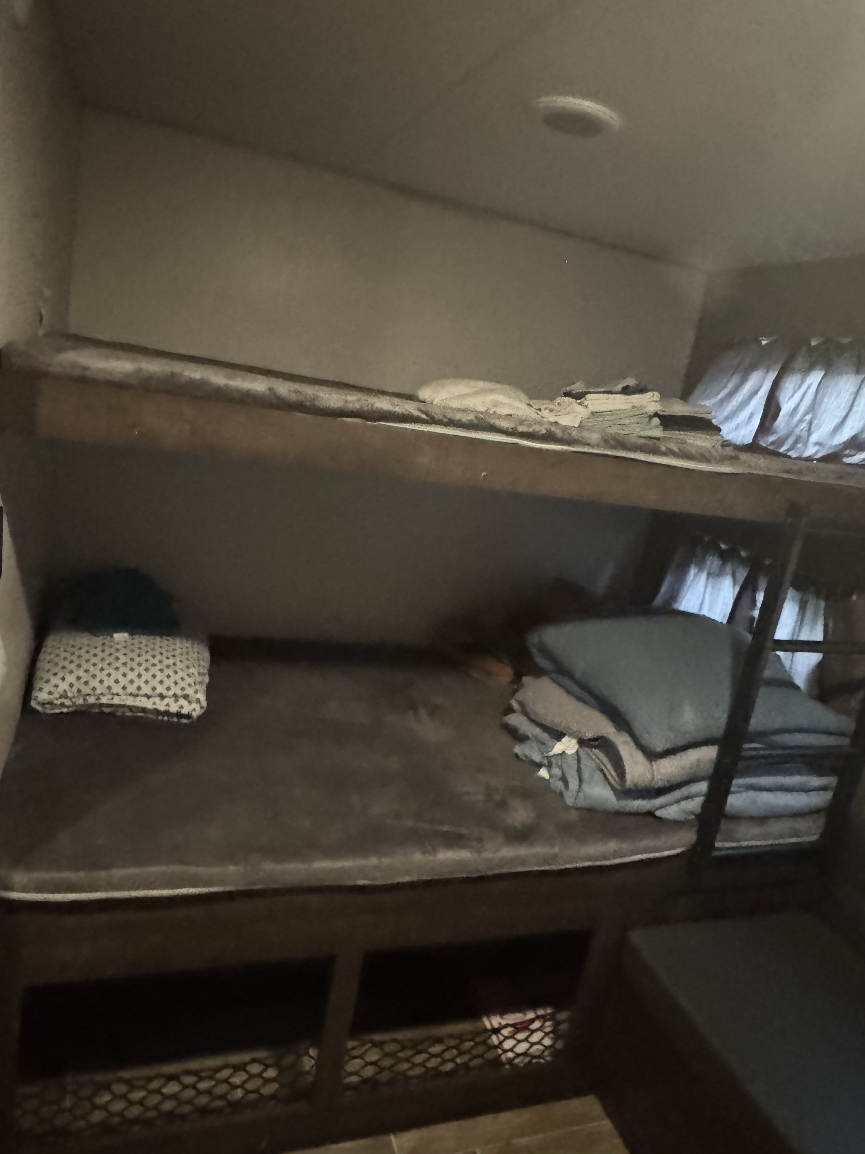 Inside an RV rental: two cozy bunk beds with soft blankets and storage. Ideal for travel and relaxation.. Sportsmen Classic 2020