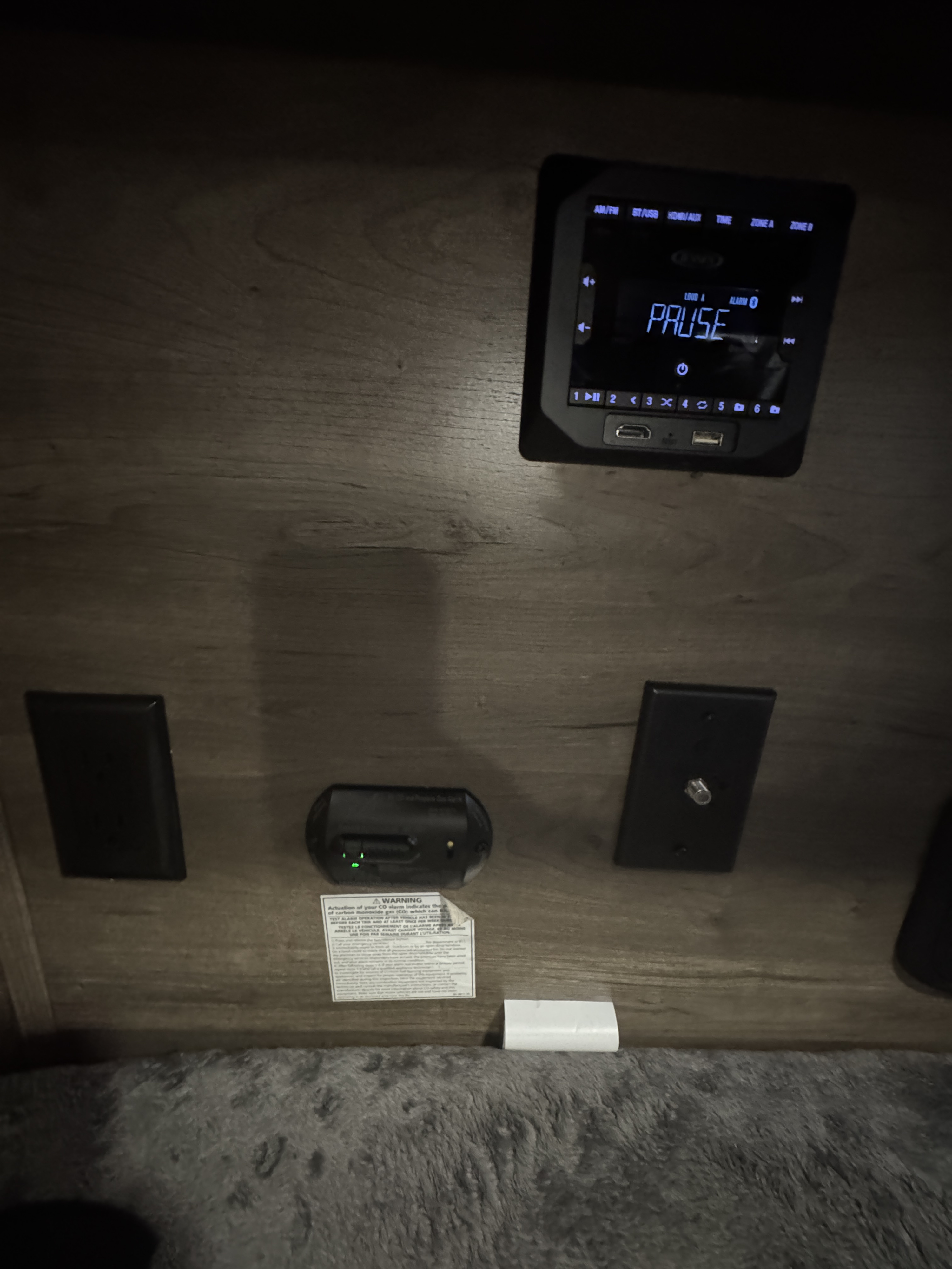 RV rental interior featuring a media player with USB/HDMI ports, a CO alarm, and cable input for entertainment and safety.. Braxton Creek Bushwhacker 2022