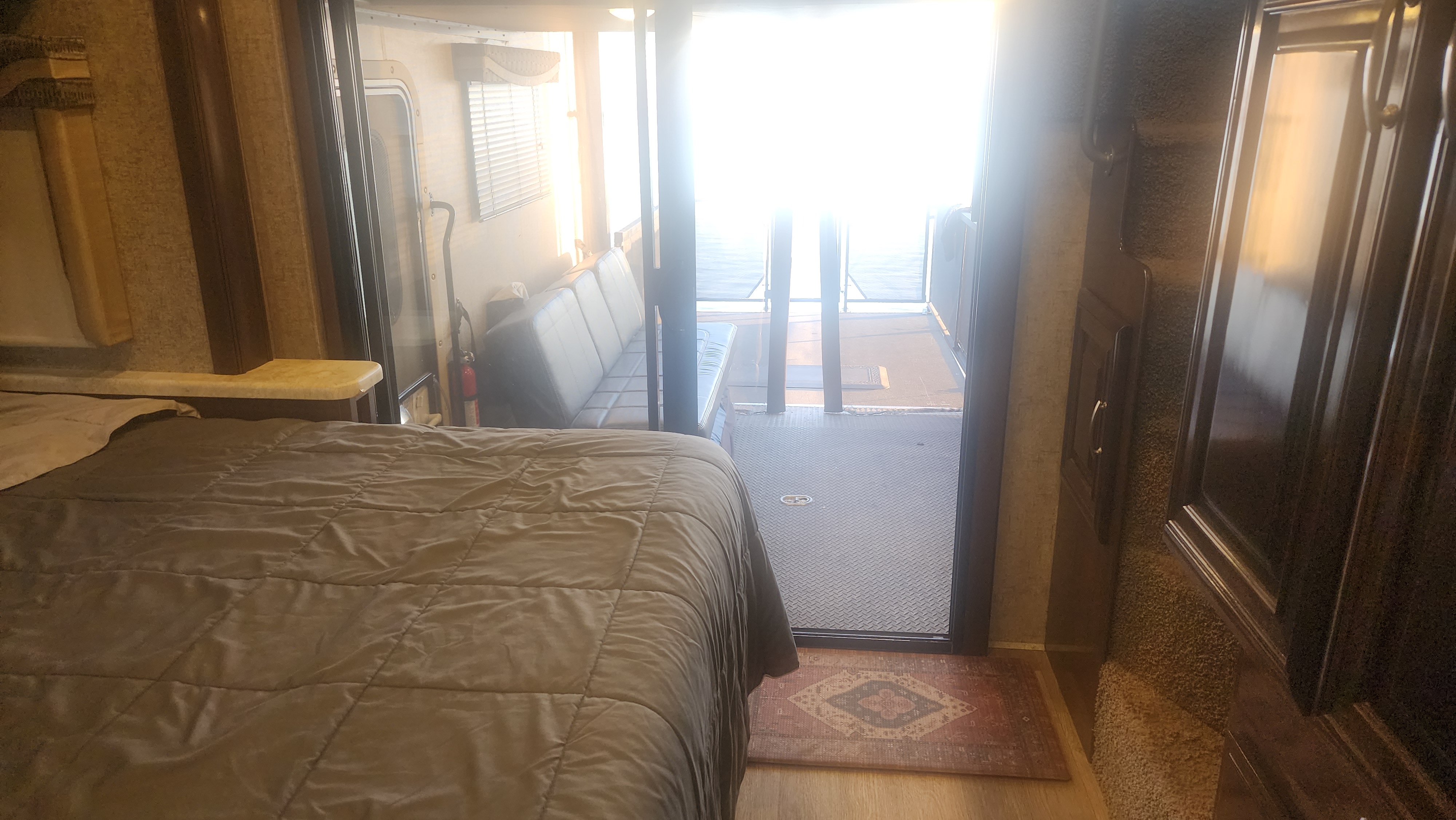 RV rental: Cozy interior featuring a bed and spacious rear patio deck, ideal for relaxing outdoors. Bright and inviting.. Thor Outlaw 2017