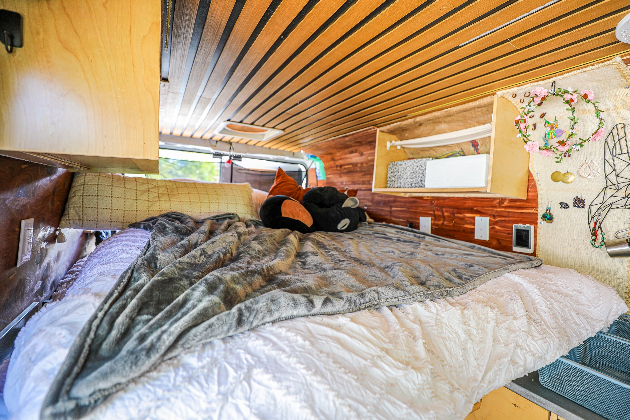 Cozy RV rental bedroom with custom wood interior, comfortable bed, and unique decor for a homey feel.. Dodge Ram Promaster Cargo Van 2500 159" WB 2018