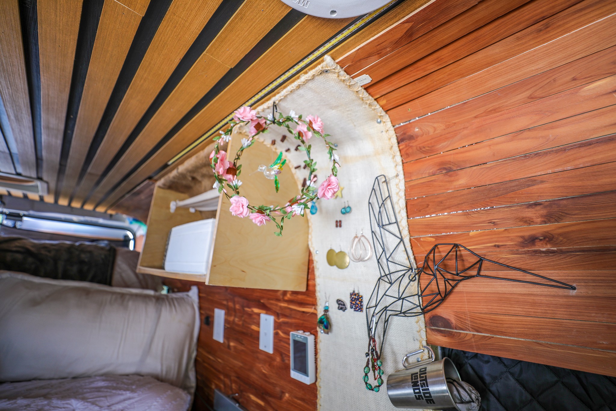 Personalized rv rental interior featuring custom wood paneling, a creative jewelry display, and cozy bed area.. Dodge Ram Promaster Cargo Van 2500 159" WB 2018