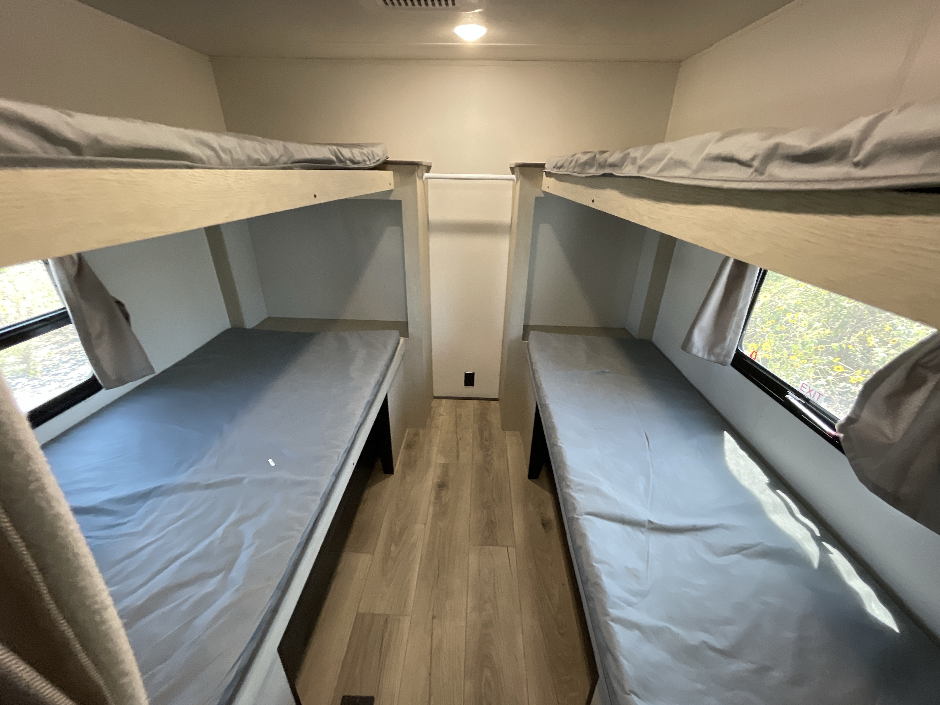 RV rental: Bright interior with dual bunk beds, windows, and light wood flooring for a compact, cozy sleeping area.. Coachmen Shasta 31QB 2025
