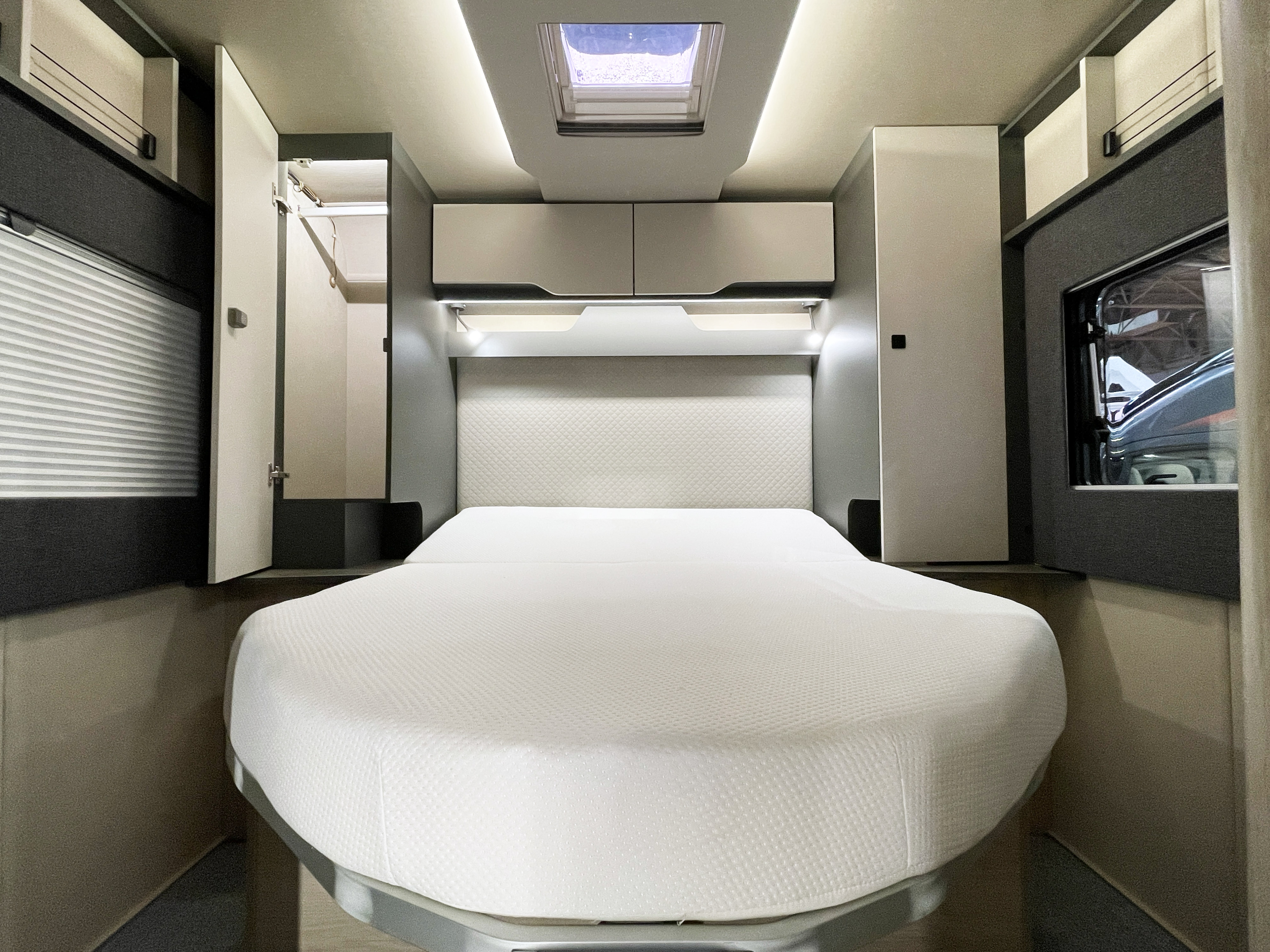 RV rental bedroom: a modern interior with a comfortable bed, overhead storage, and integrated lighting. Perfect for travel.. Auto-Trail F74 2026