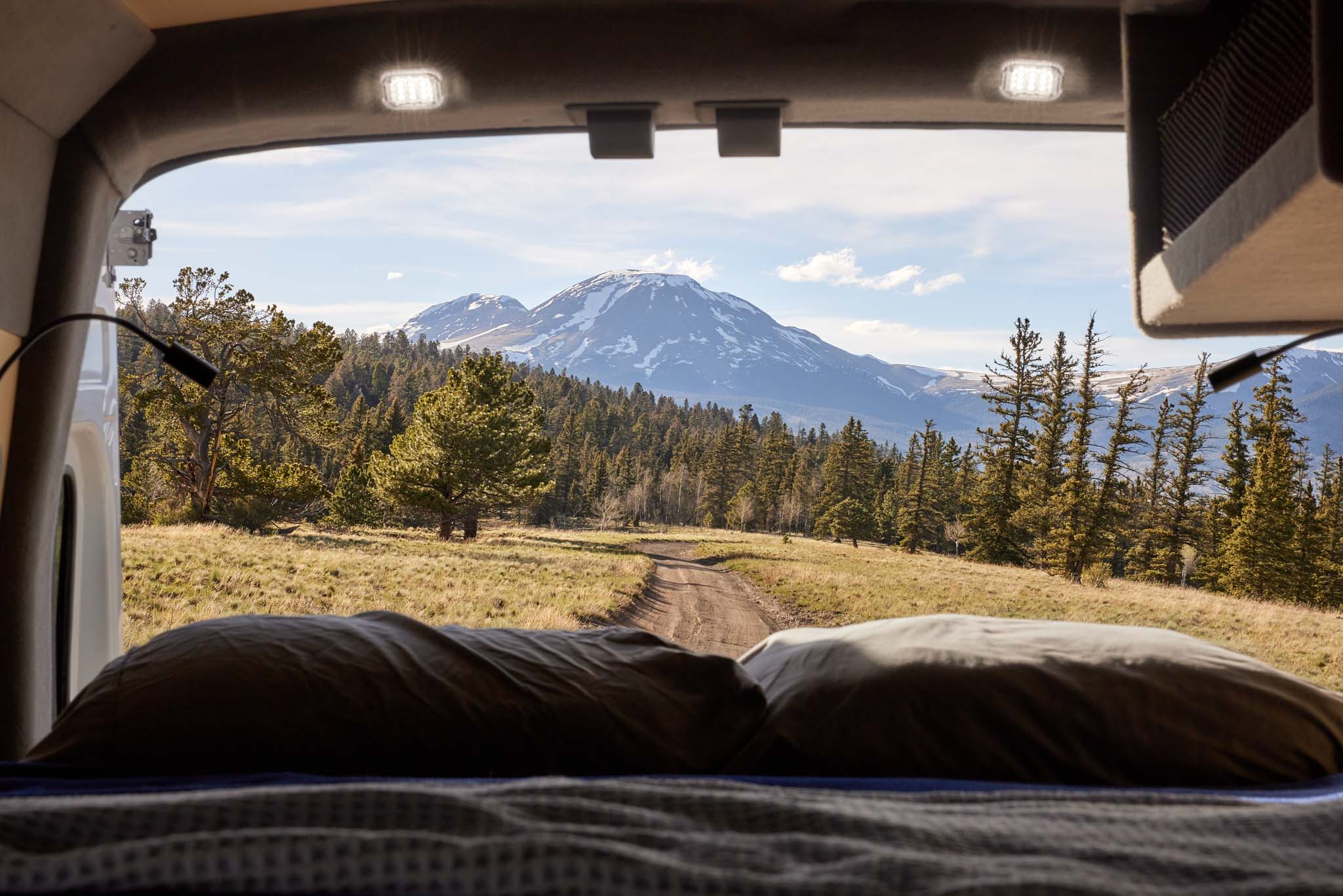Wake up to stunning mountain views from your comfortable rv rental bed. Explore nature on your next adventure.. Ford Transit 2023