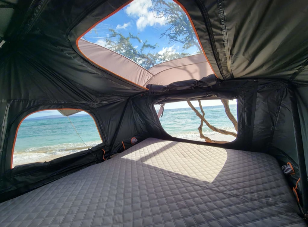 Panoramic beach views from an RV rental's rooftop tent! Features a comfy mattress overlooking turquoise ocean and trees.. Toyota 4Runner Premium 2020