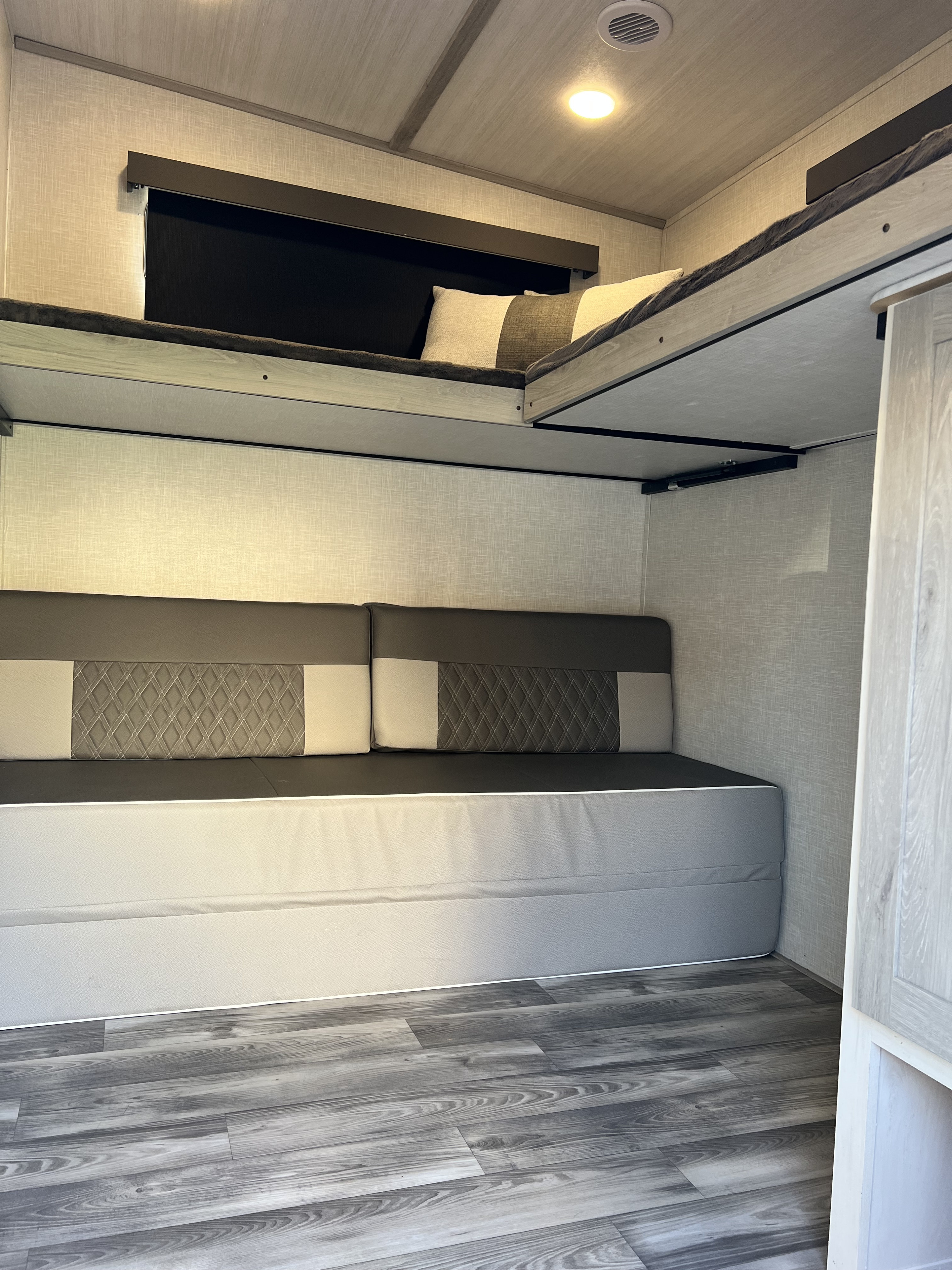 RV rental bunkhouse: modern design with upper bunks & a lower convertible sofa/bed.. Forest River Impression 2021