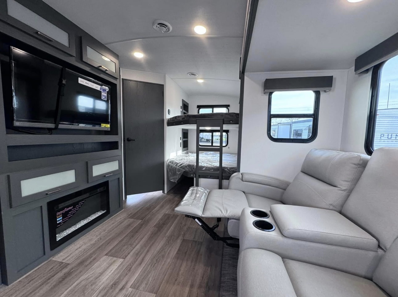 RV rental interior featuring reclining seating, TV, fireplace, and bunk beds for comfortable travel.. Keystone RV Bullet Ultra Lite 2024