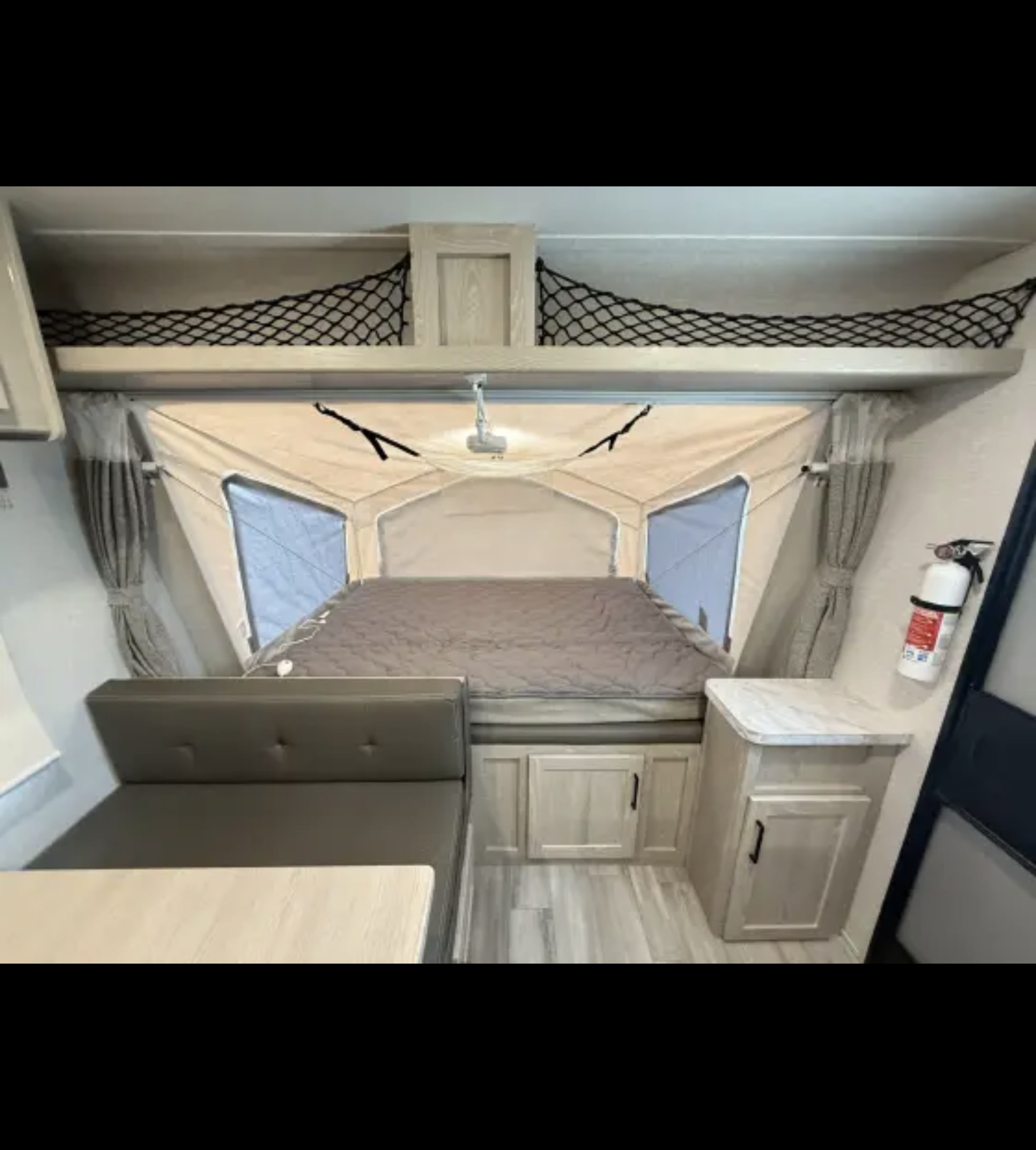 Experience comfort in this RV rental! Features a pop-out bed, dinette, storage, and safety features like a fire extinguisher.. Forest River Flagstaff Shamrock 2022