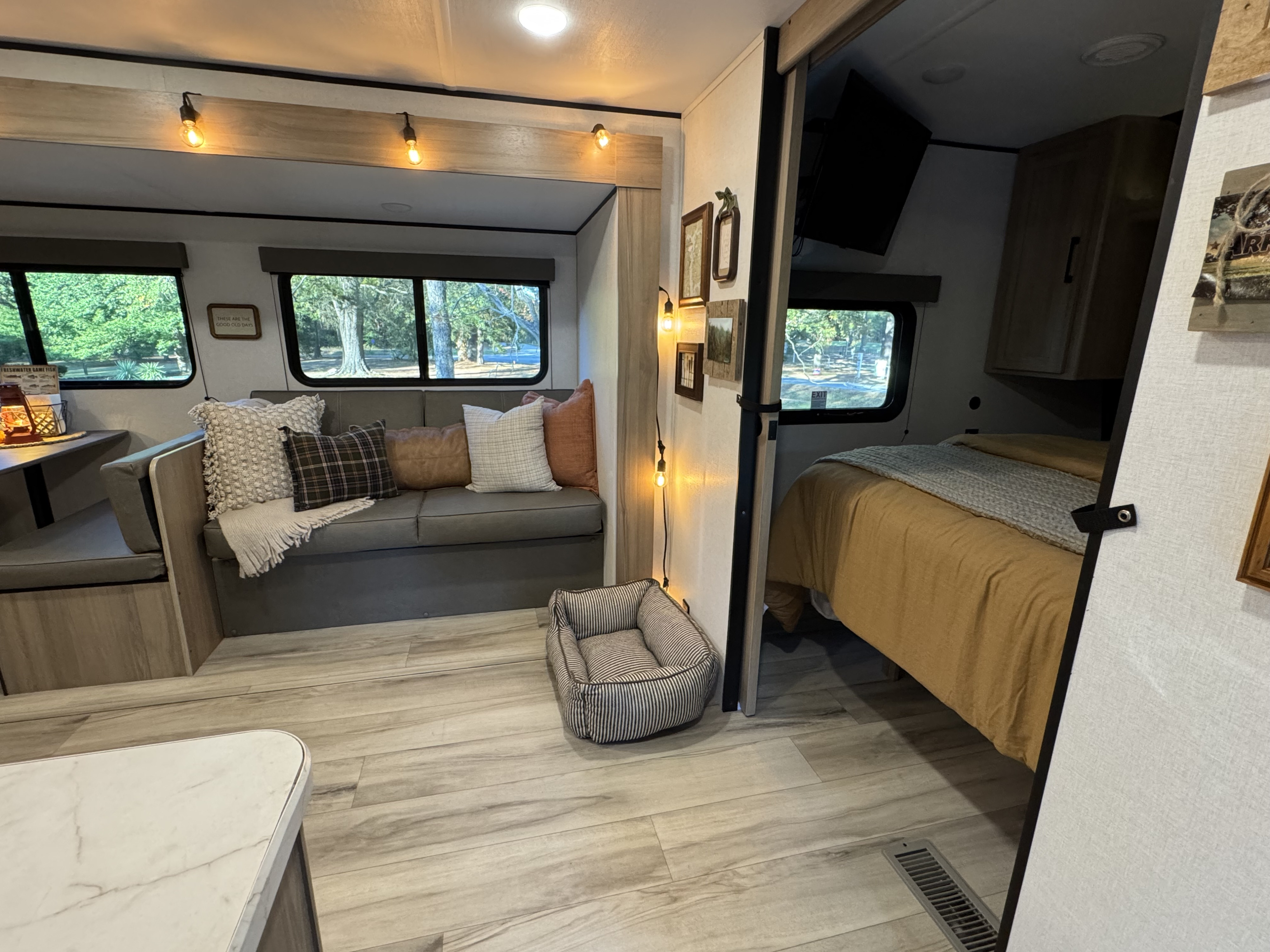 Cozy RV rental interior with a welcoming living area, comfortable bedroom, and a dog bed for your furry friend.. Keystone RV Coleman 2025