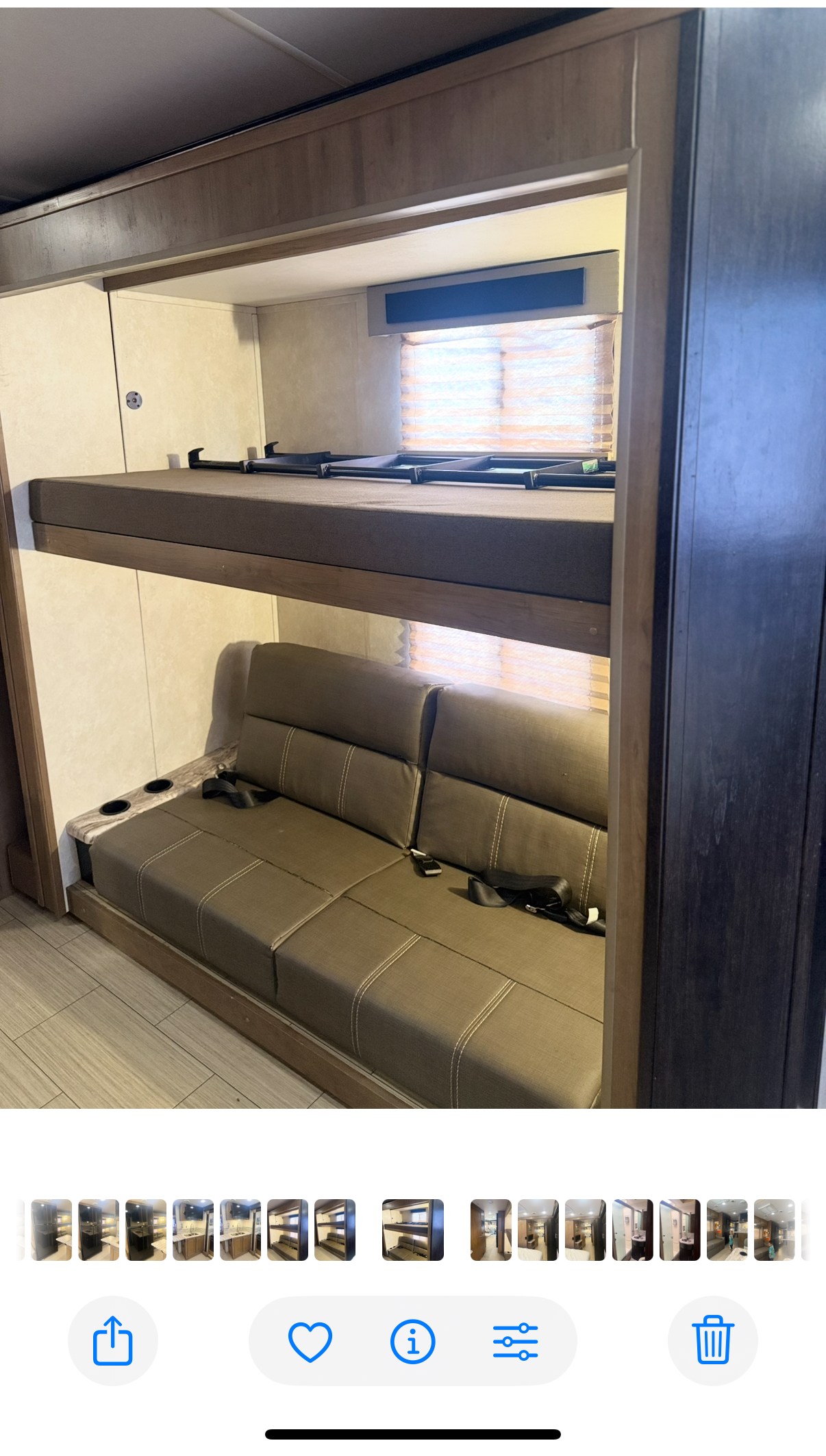 Comfortable RV rental interior featuring a top bunk bed with safety straps and a cozy sofa bed below with cup holders. Perfect for family trips!. FR3 FR3 Motorhome 2019