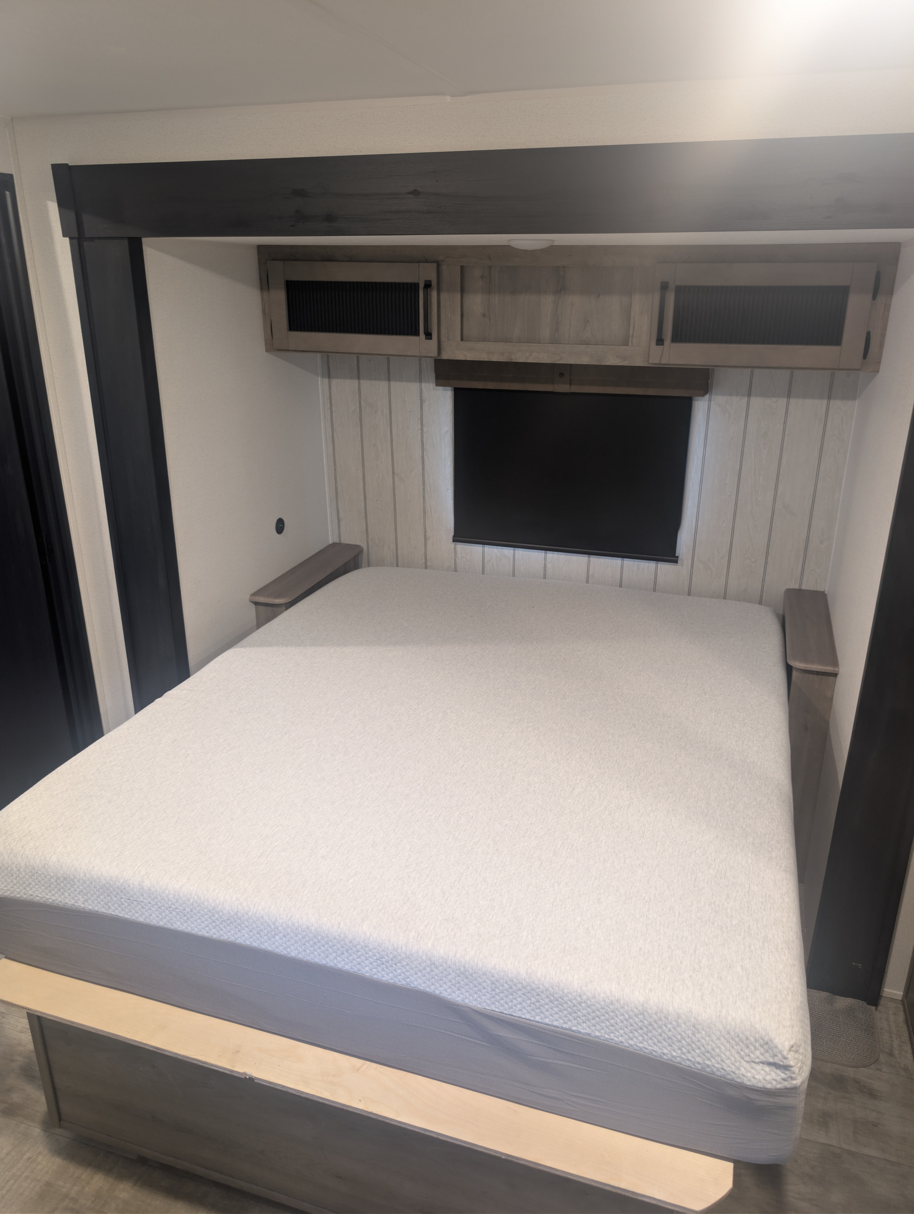 Modern RV rental bedroom featuring a comfortable bed, overhead storage, and blackout blind for a cozy sleep space.. Forest River Palomino Puma 2025