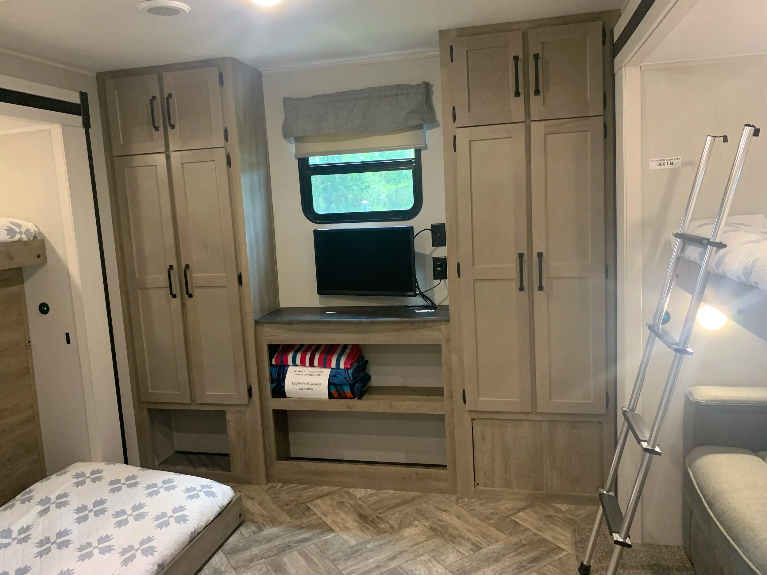 This RV rental features bunk beds (300 lb capacity), a TV, and ample storage, perfect for a Disney vacation.. Forest River Puma 2023