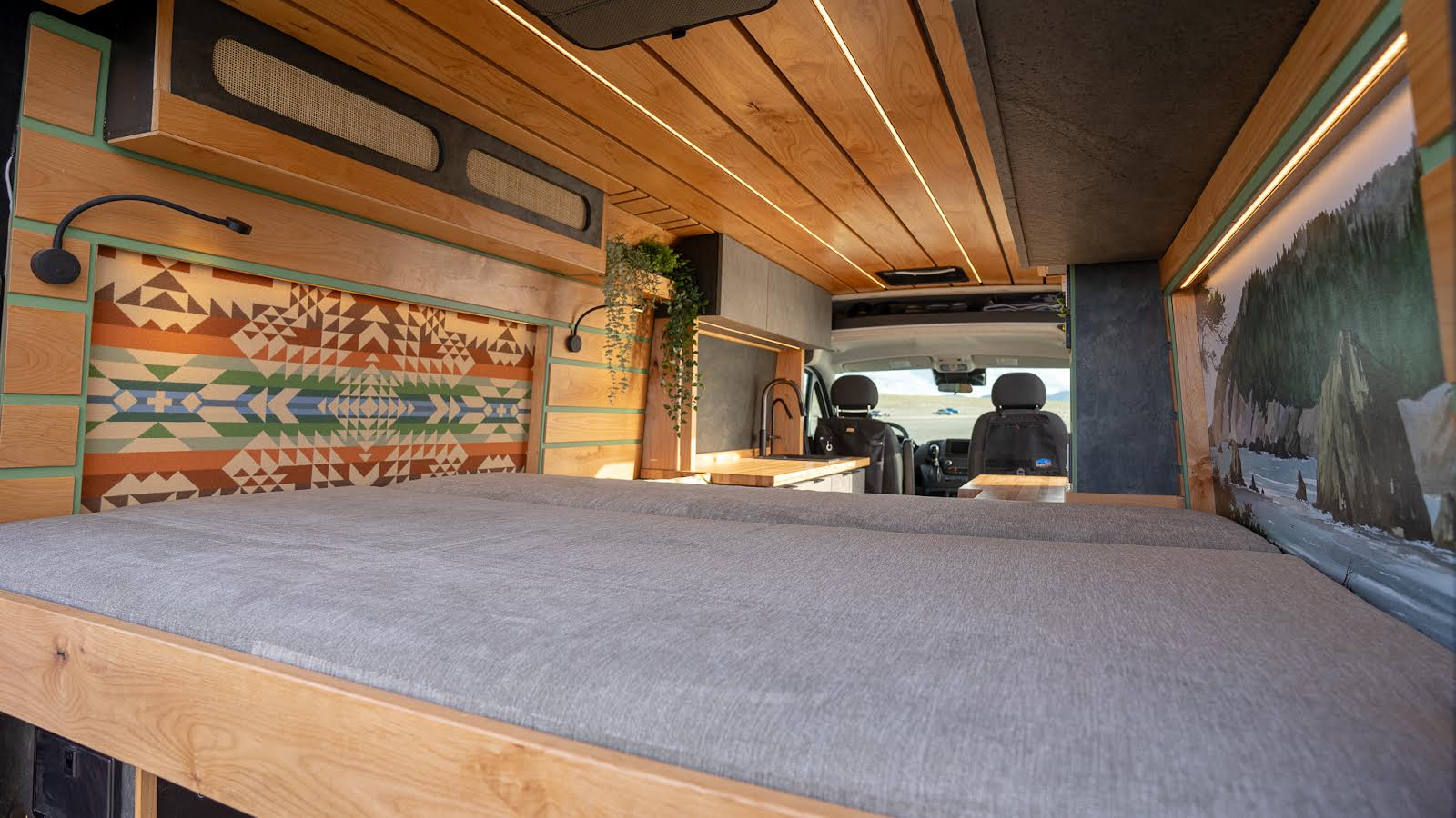 Explore the open road in this RV rental! Enjoy a warm wood interior, comfortable bed, colorful headboard, and functional kitchen.. Travelcraft Motor Home 2023