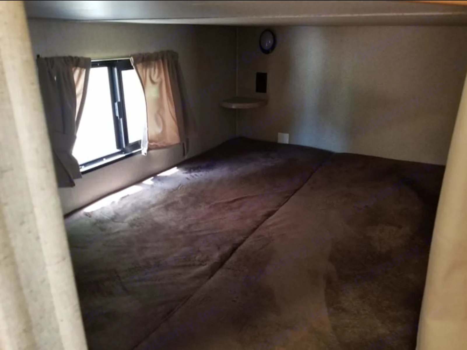 Cozy RV rental bunk bed with window, perfect for compact sleeping in a travel trailer.. Crossroads RV Sunset Trail Super Lite 2017