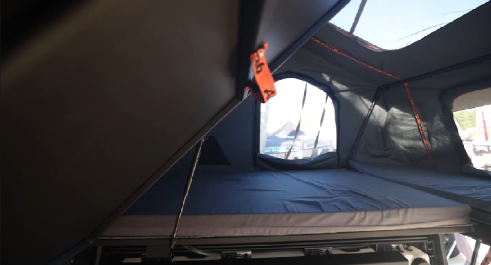 Step inside this **rv rental** rooftop tent! Features a soft mattress, window views, and sturdy construction for camping.. Toyota Tundra 2019