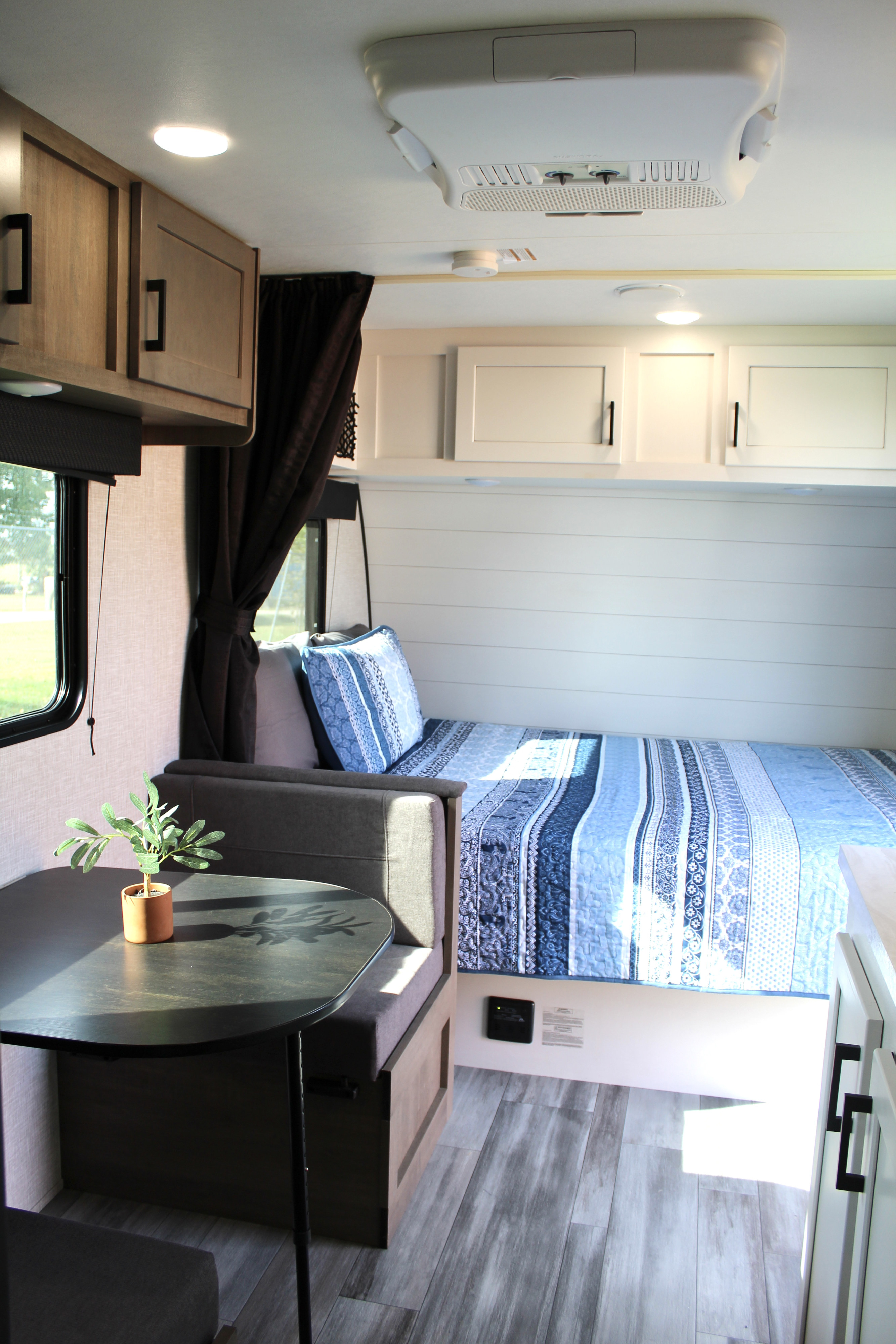 Bright RV rental interior featuring a comfy bed, functional dinette, ample cabinets, and stylish wood-look flooring.. Jayco Jay Flight SLX 2024