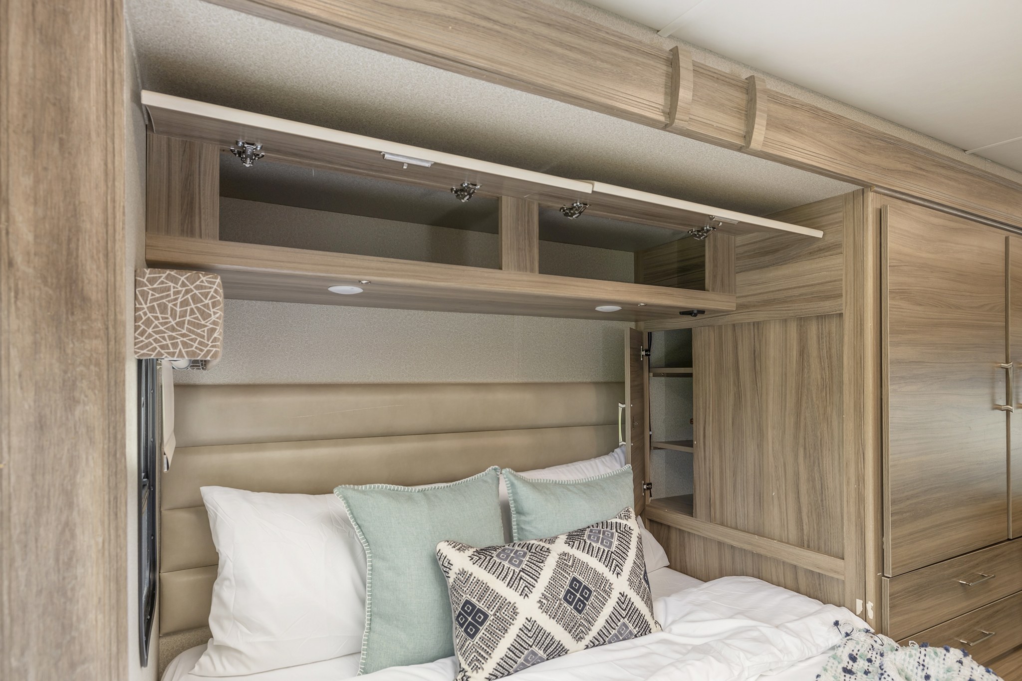 Comfortable RV rental bedroom with ample overhead and side storage, plush bedding, and modern decor.. Jayco Melbourne 2018