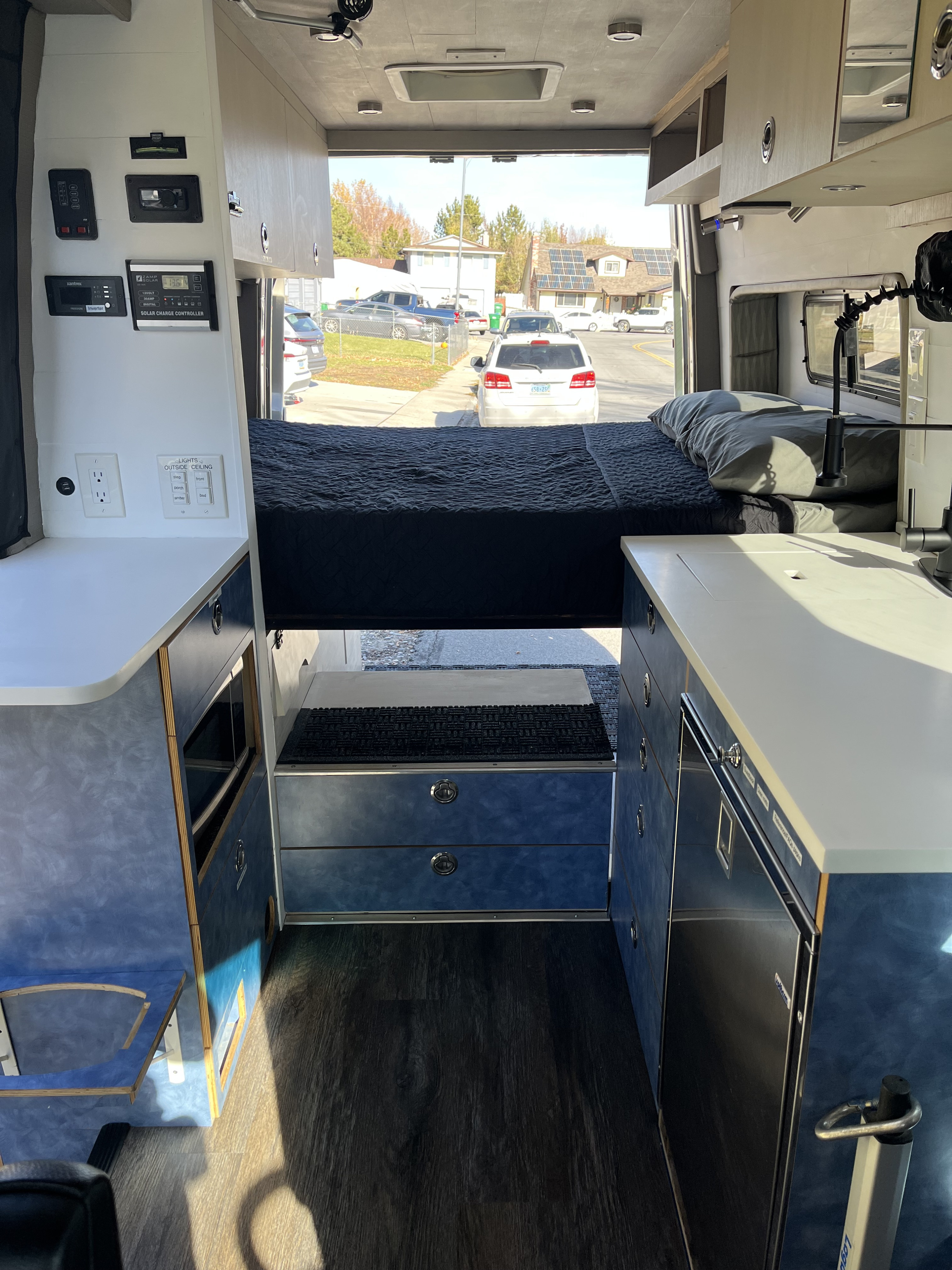 Cozy rv rental interior: bed, kitchenette, and controls clearly visible, perfect for your next adventure.. Mercedes Sprinter 2017