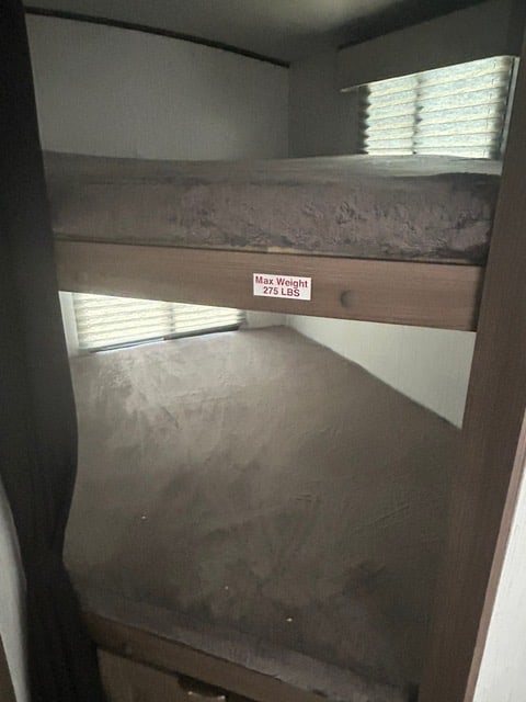 Inside an RV rental: comfortable bunk beds, with a 275 lbs weight limit on the top bunk, ready for your next trip.. Cruiser RV MPG 2023