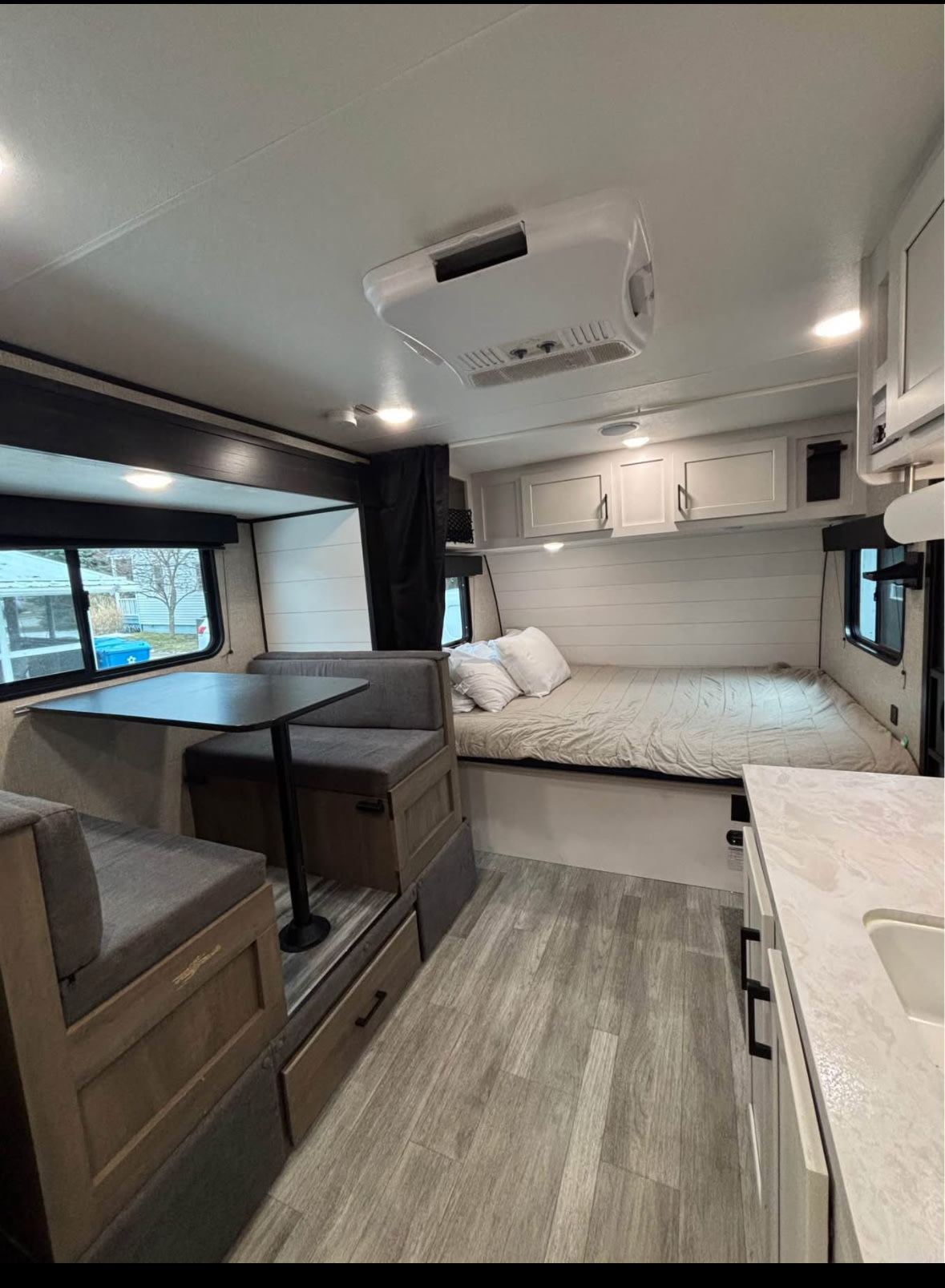 Spacious RV rental interior featuring a dinette, comfortable bed, and kitchenette, ideal for camper adventures.. Jayco Jay Flight SLX 2024