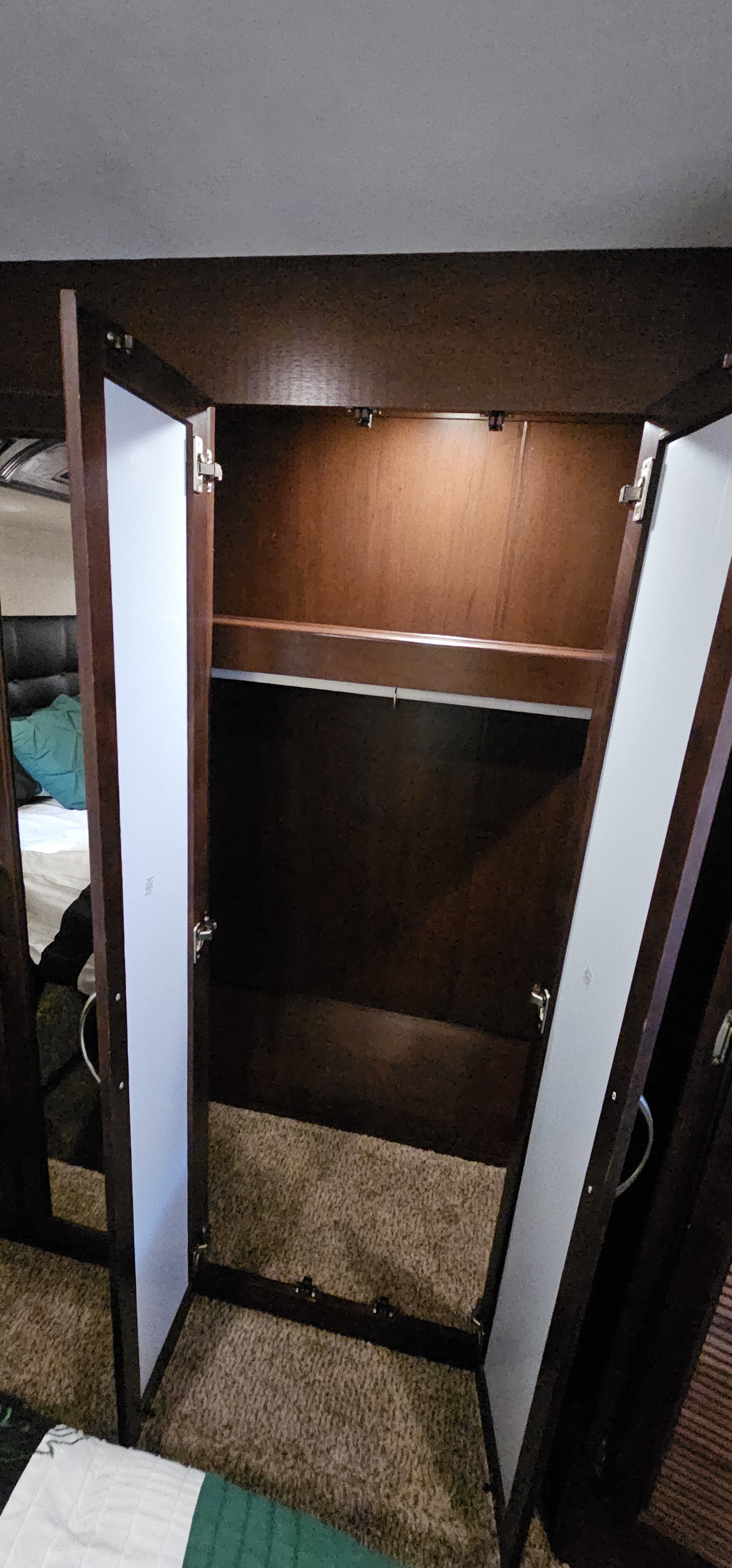 RV rental bedroom closet: open wooden wardrobe with hanging rod & shelf. Ideal storage for your travels.. Heartland Cyclone 2015