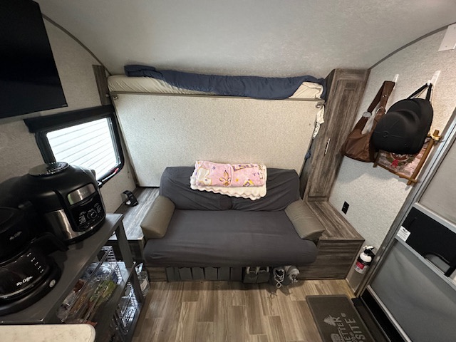 Compact rv rental interior with a bunk bed, sofa, kitchenette, and essentials. Perfect for functional living space.. Forest River Salem FSX PLATINUM 2020