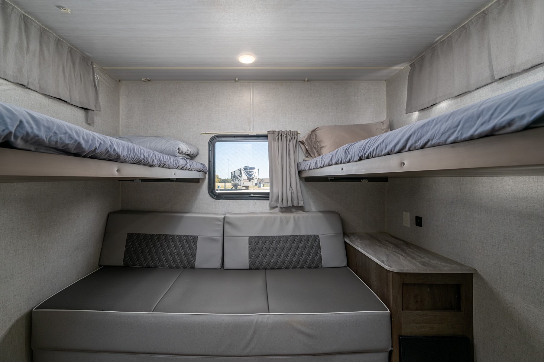 This RV rental features comfortable bunk beds and a versatile sofa/dinette area, perfect for family sleeping and living space.. Forest River Wildwood 2022