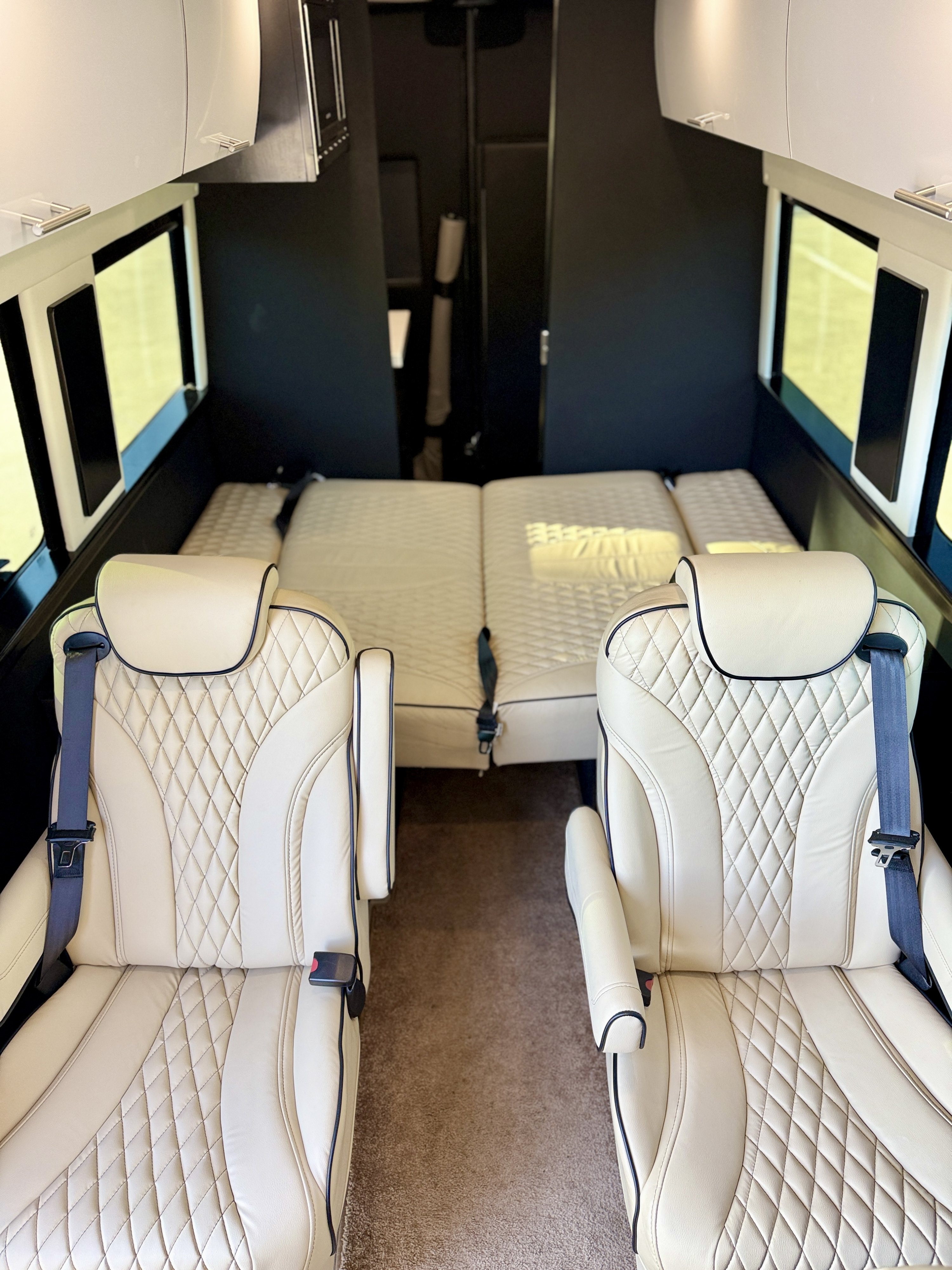 Experience premium comfort in this rv rental, featuring luxurious cream, quilted captain's chairs and a spacious sleeping area in a modern camper van.. Regency RV Zalta 2023