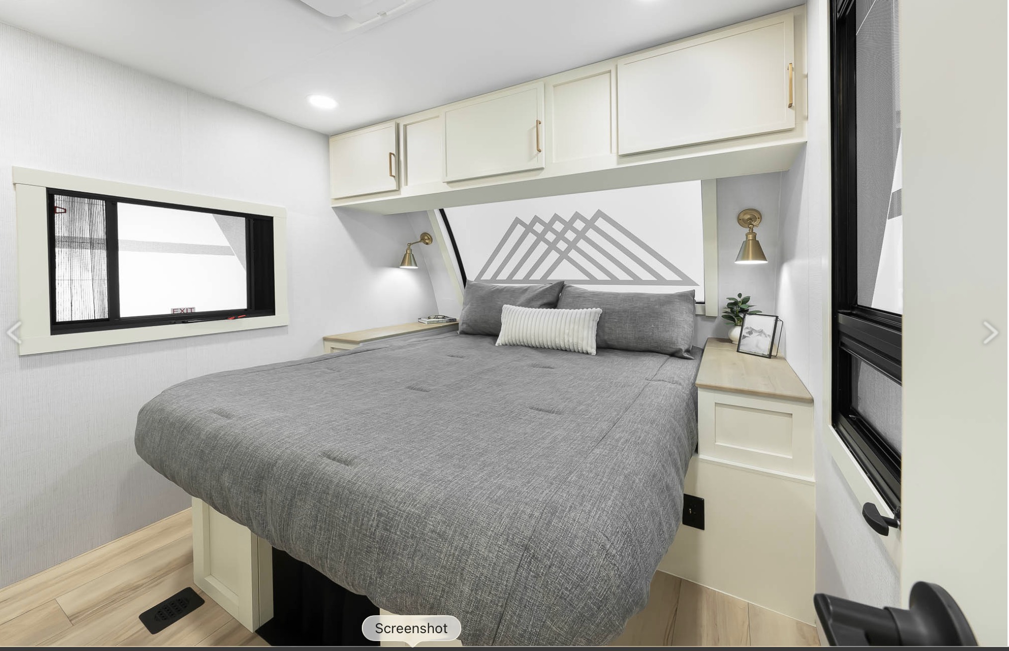 Spacious rv rental bedroom with a large bed, gray bedding, and stylish mountain mural. Bright interior, ideal for comfy travel.. Brinkley RV Model I 2025