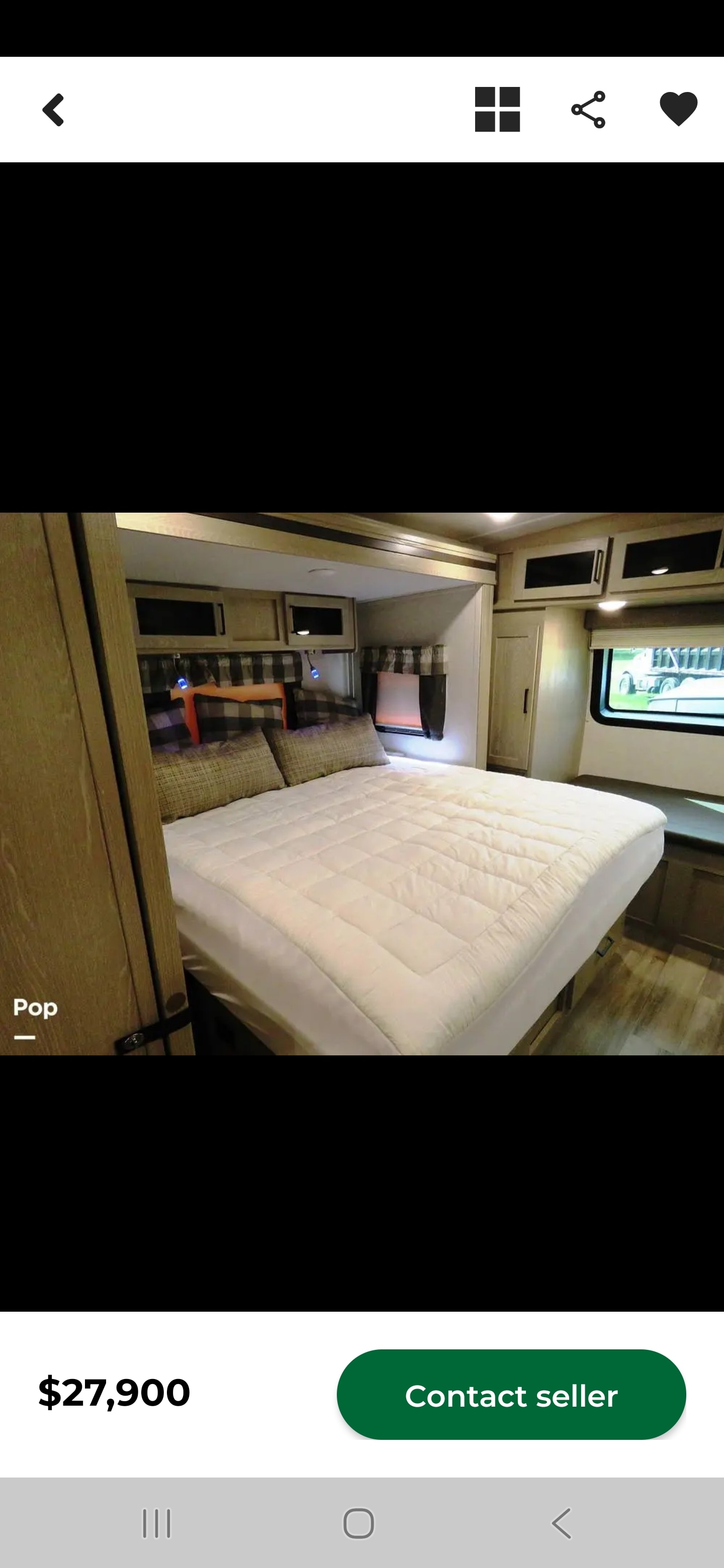 Cozy RV rental bedroom featuring a comfortable bed with a white quilt, pillows, storage cabinets, and a window.. Forest River Flagstaff Super Lite 2021