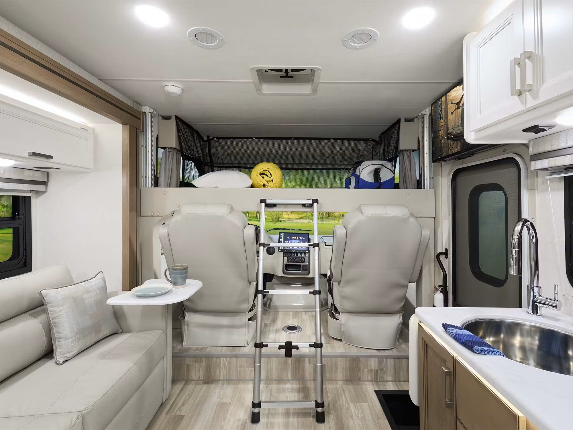 Cozy rv rental interior featuring an overhead bunk bed, comfortable seating, and a functional kitchen. Ready for travel.. Axis 24.1 2026
