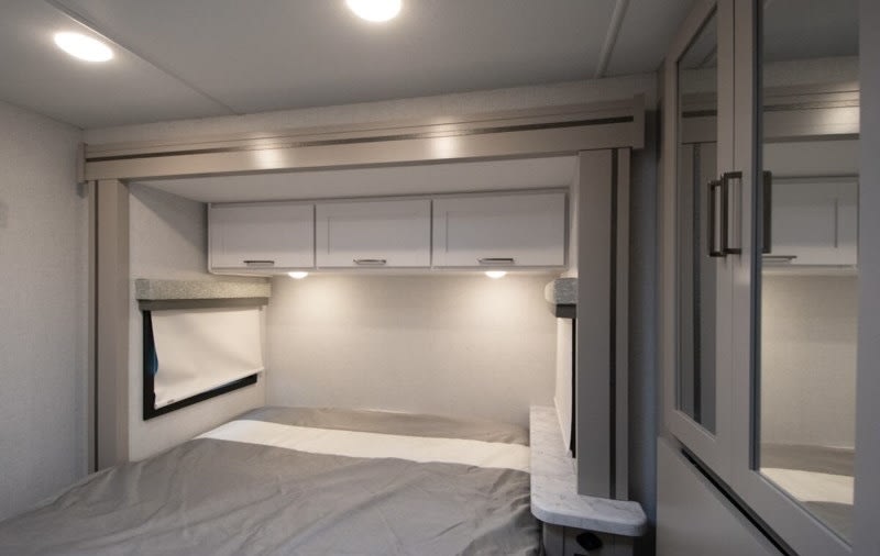 Cozy RV rental bedroom interior with modern design, overhead storage, and good lighting for your travels.. Four Winds 22Z 2026