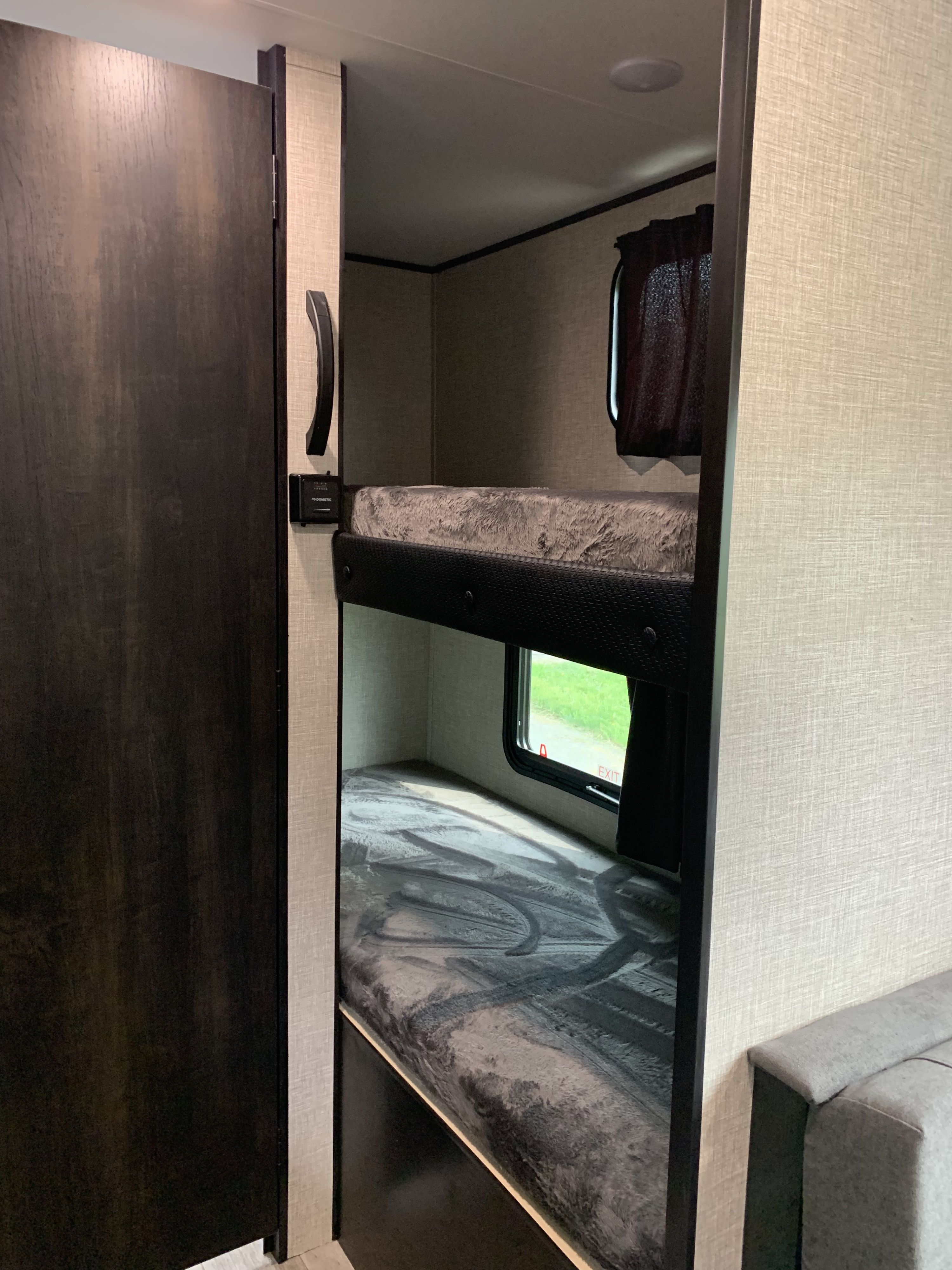 This RV rental features two bunk beds with windows, soft mattresses, and a Dometic control, providing cozy sleeping for your trip.. Jayco Jay Flight SLX STX Edition 2022