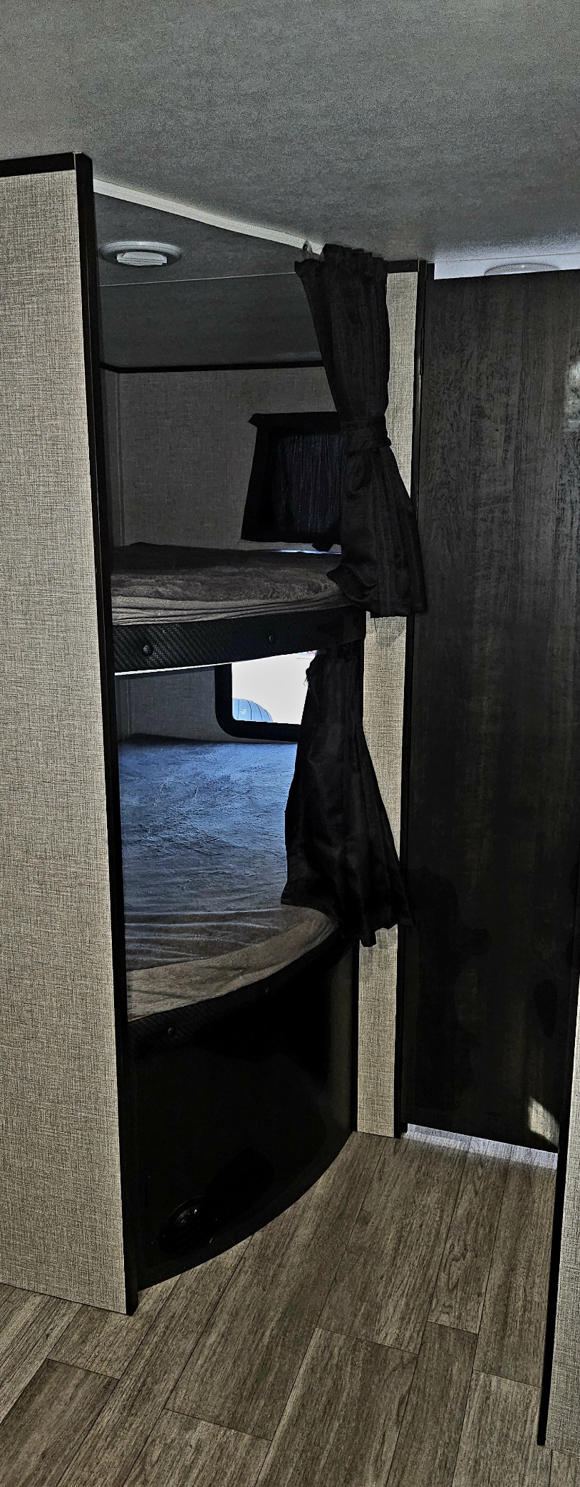 Interior of an rv rental: cozy bunk beds with privacy curtains and a lower window, perfect for comfortable sleeping.. Jayco Jay Flight SLX 2022