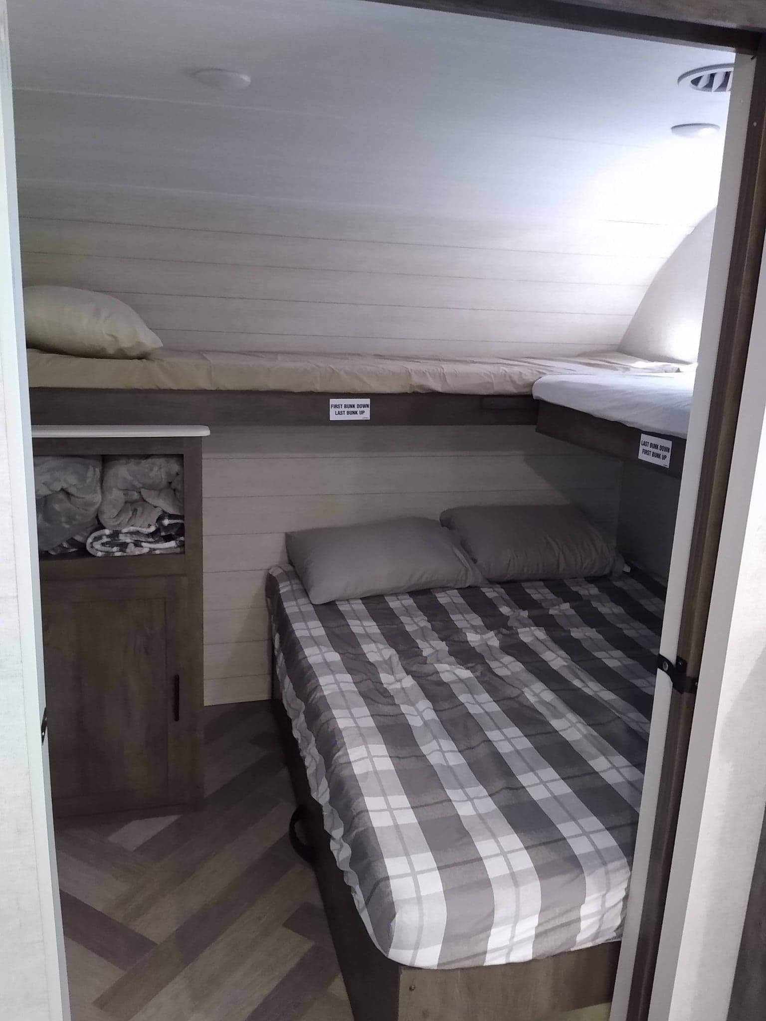This cozy RV rental features stacked bunk beds, providing comfortable sleeping for multiple guests, with built-in storage.. Salem 36VBDS 2021