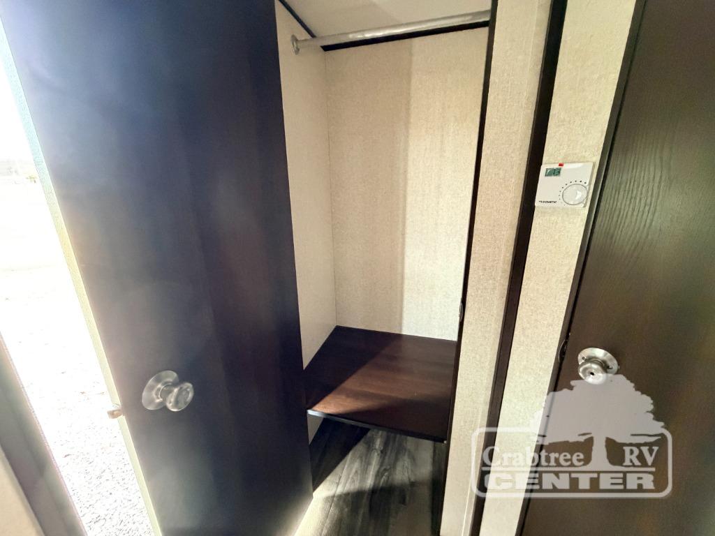 RV rental interior featuring a practical closet with hanging rod, shelf, and climate control thermostat.. Jayco Jay Flight SLX 2019