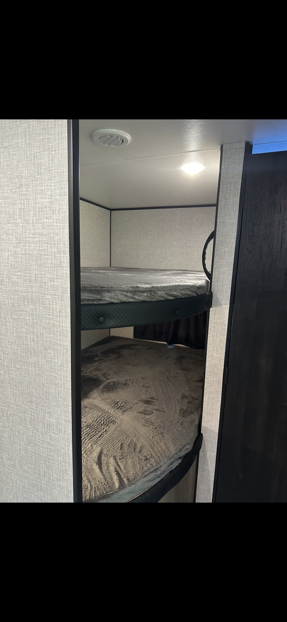 Explore our cozy rv rental interior! This image features comfortable bunk beds with soft grey bedding, ideal for family travel.. Jayco Jay Flight SLX 2024