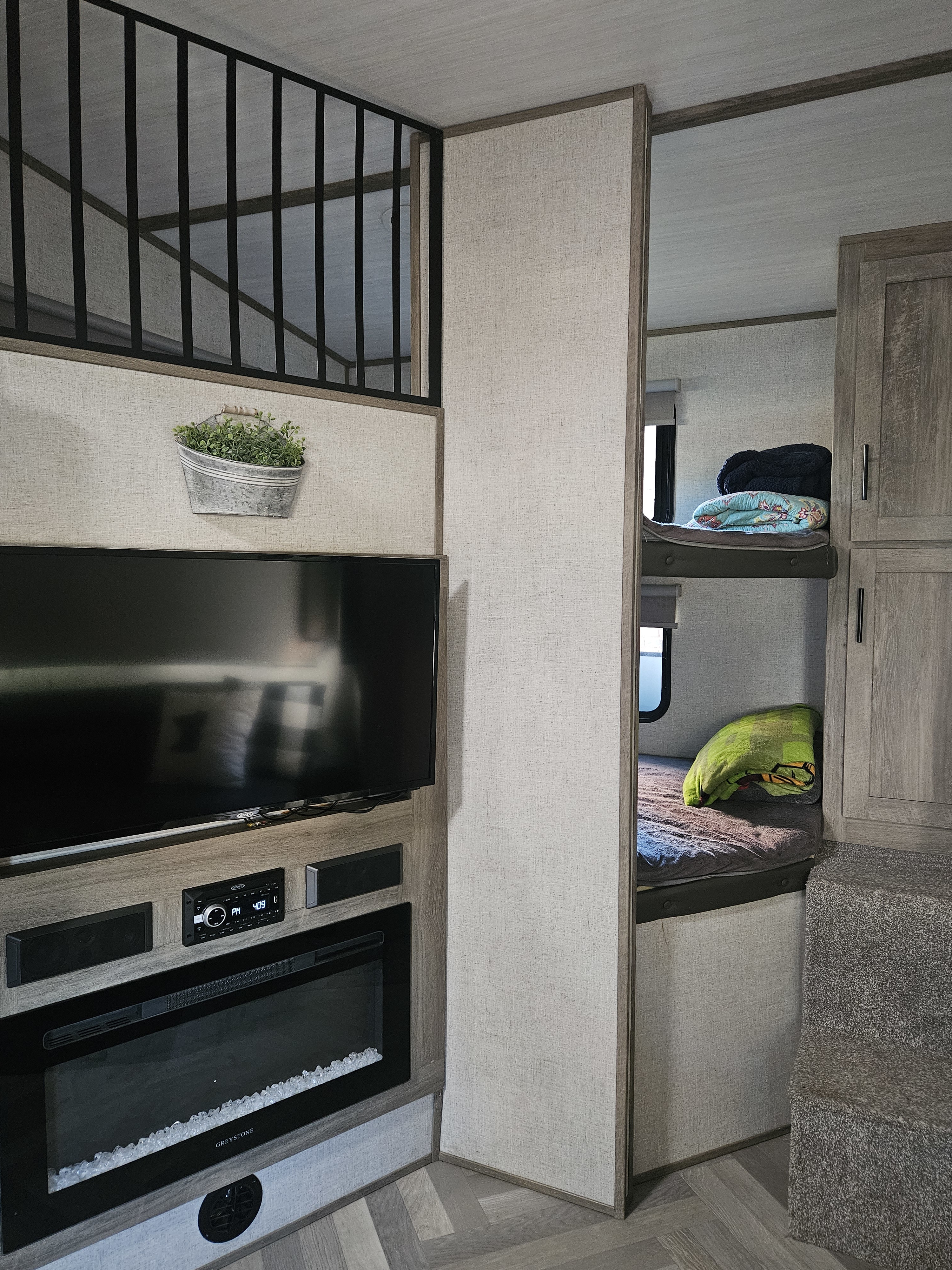 Inside a modern rv rental: TV, electric fireplace, cozy bunks, and loft area. Perfect for a family adventure.. Forest River Salem Hemisphere 2021