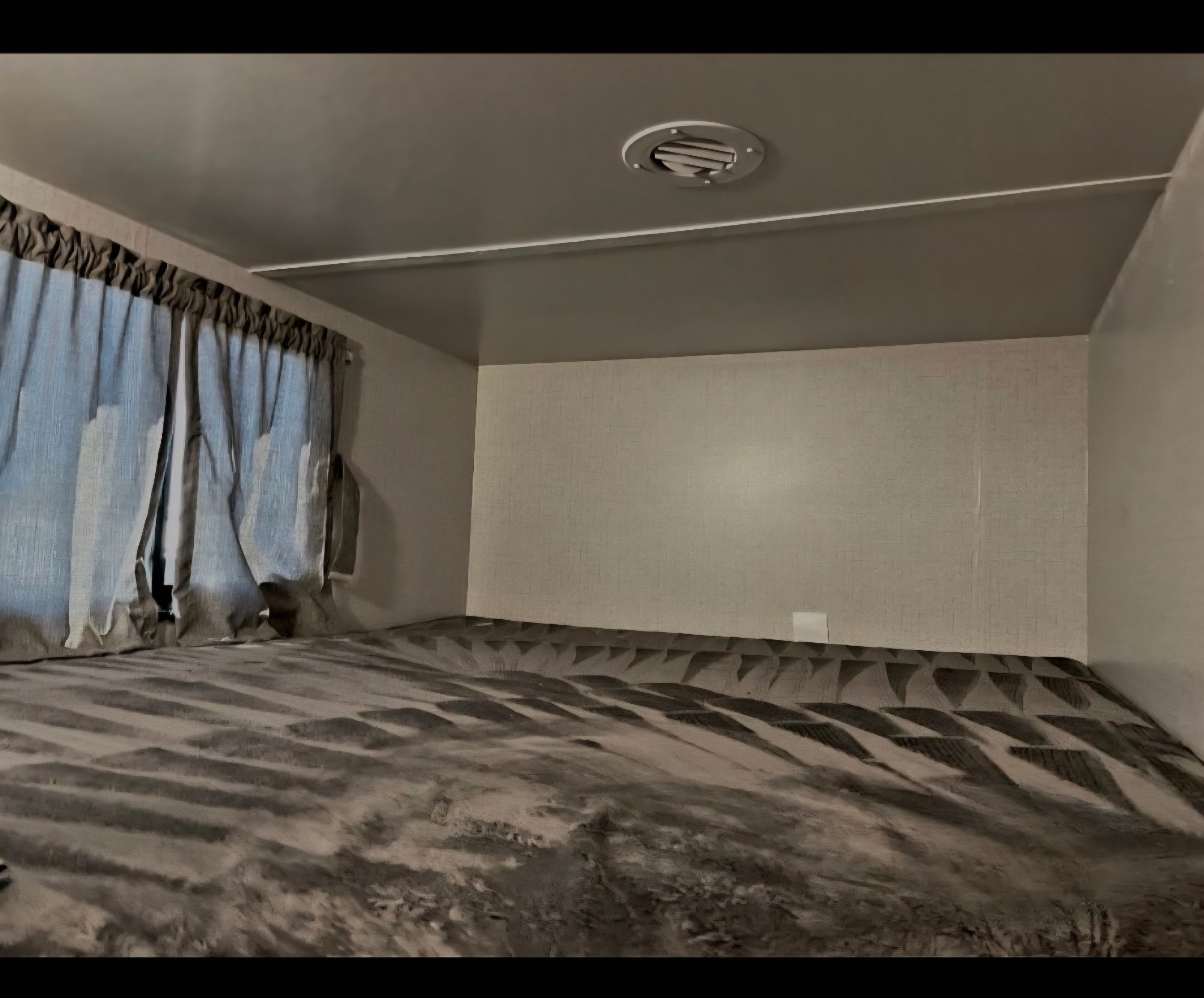 Inside an RV rental: a comfortable bunk bed with soft grey patterned bedding, window curtains, and a ceiling AC vent.. Winnebago Voyage 2022