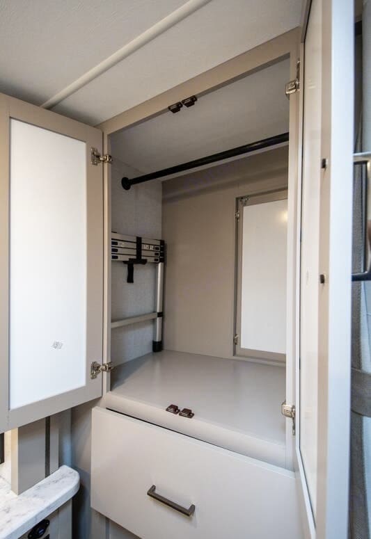 RV rental: Compact interior closet features a clothes rod, drawer, and foldable ladder for convenient, organized storage.. Four Winds 22Z 2026